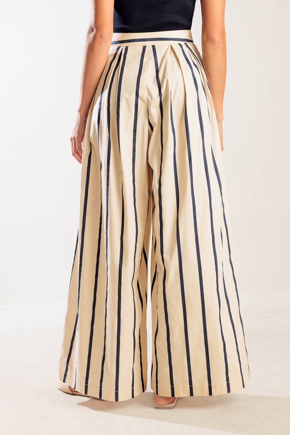 A striped woven pant featuring side zipper closure and wide leg.