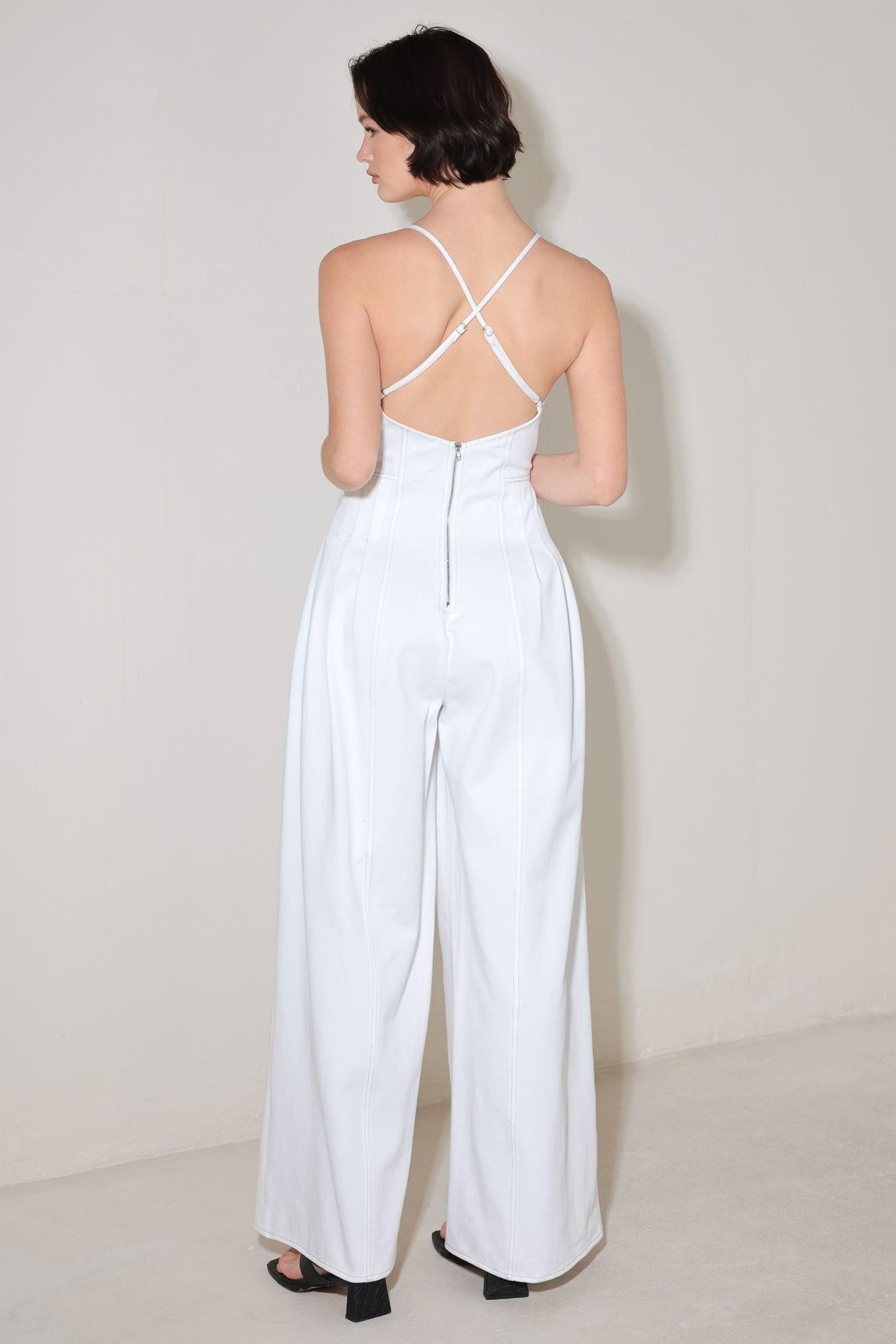 A solid woven jumpsuit featuring cami top, side pleats, wide leg, bare back with cross straps and zipper closure
Details:
Self : 100% Cotton
Size & Fit
- Model is 5`8" And Wearing Size Small
- Measurements Taken From Size Small
- Approx. Length: 58"