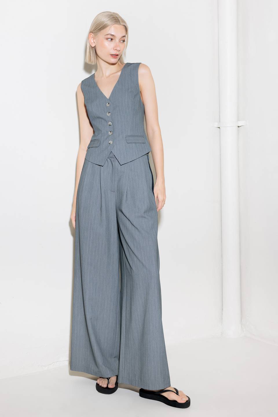A striped woven pant featuring contrasting edge waist band, front pleat, side pockets, side stripe detail and wide leg.