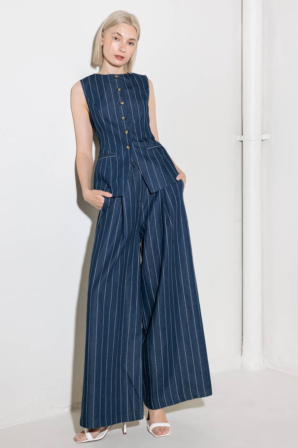 A striped woven pant featuring front closure, side tab, pockets and wide leg.