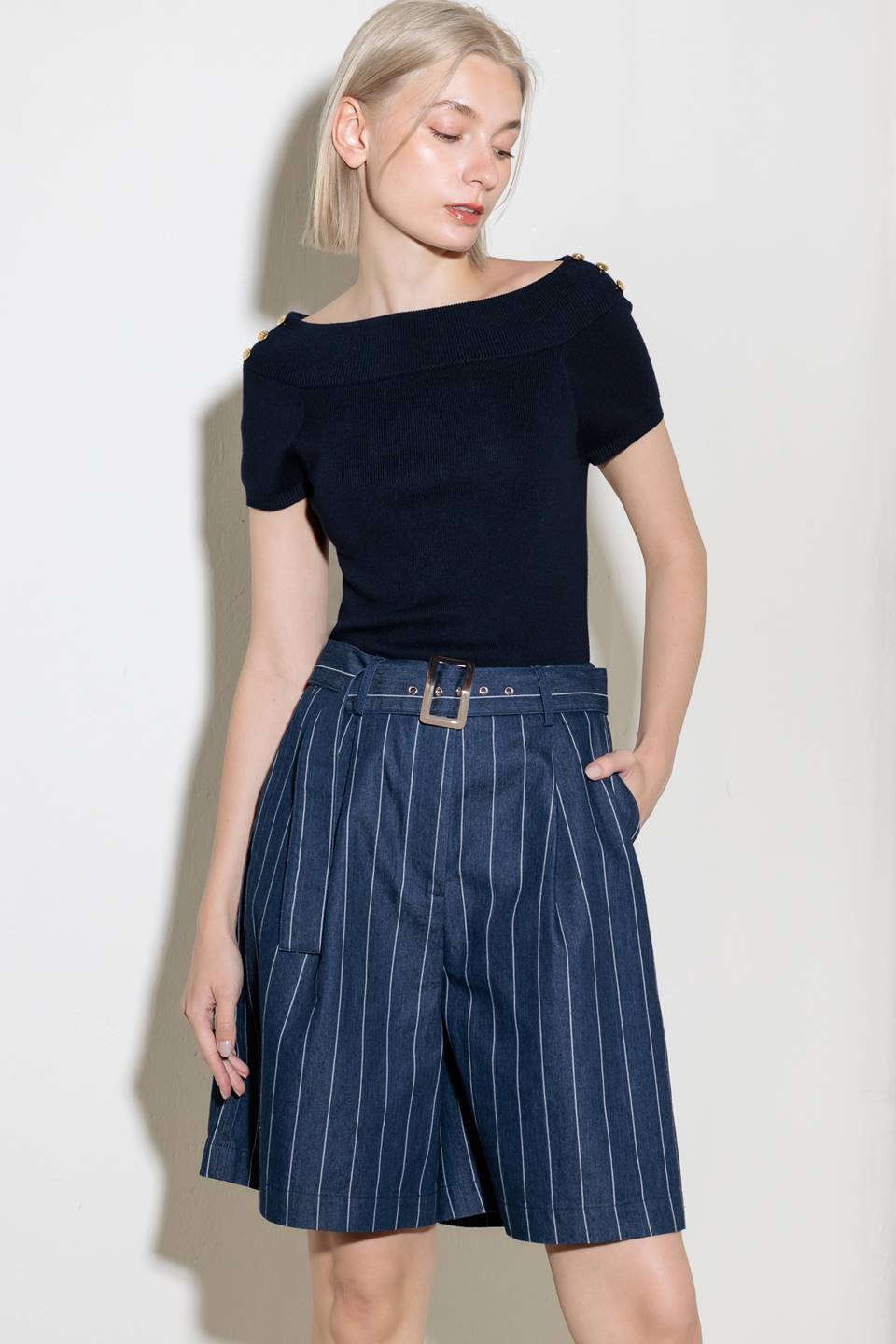 A striped woven bermuda short featuring self belt and side pocket.
