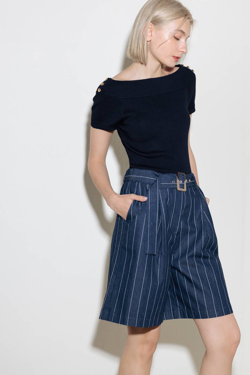A striped woven bermuda short featuring self belt and side pocket.