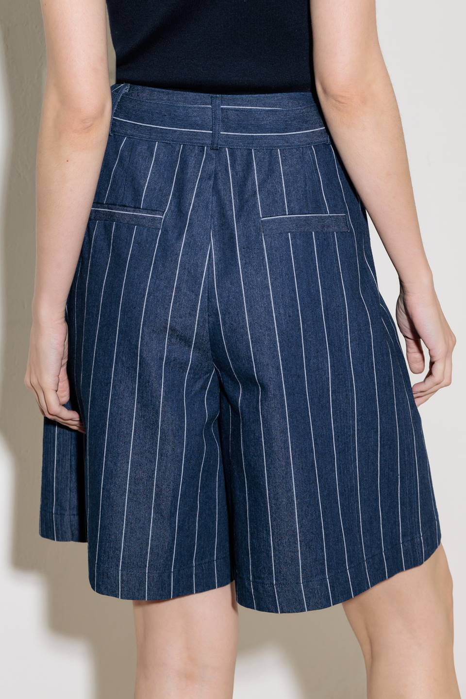 A striped woven bermuda short featuring self belt and side pocket.