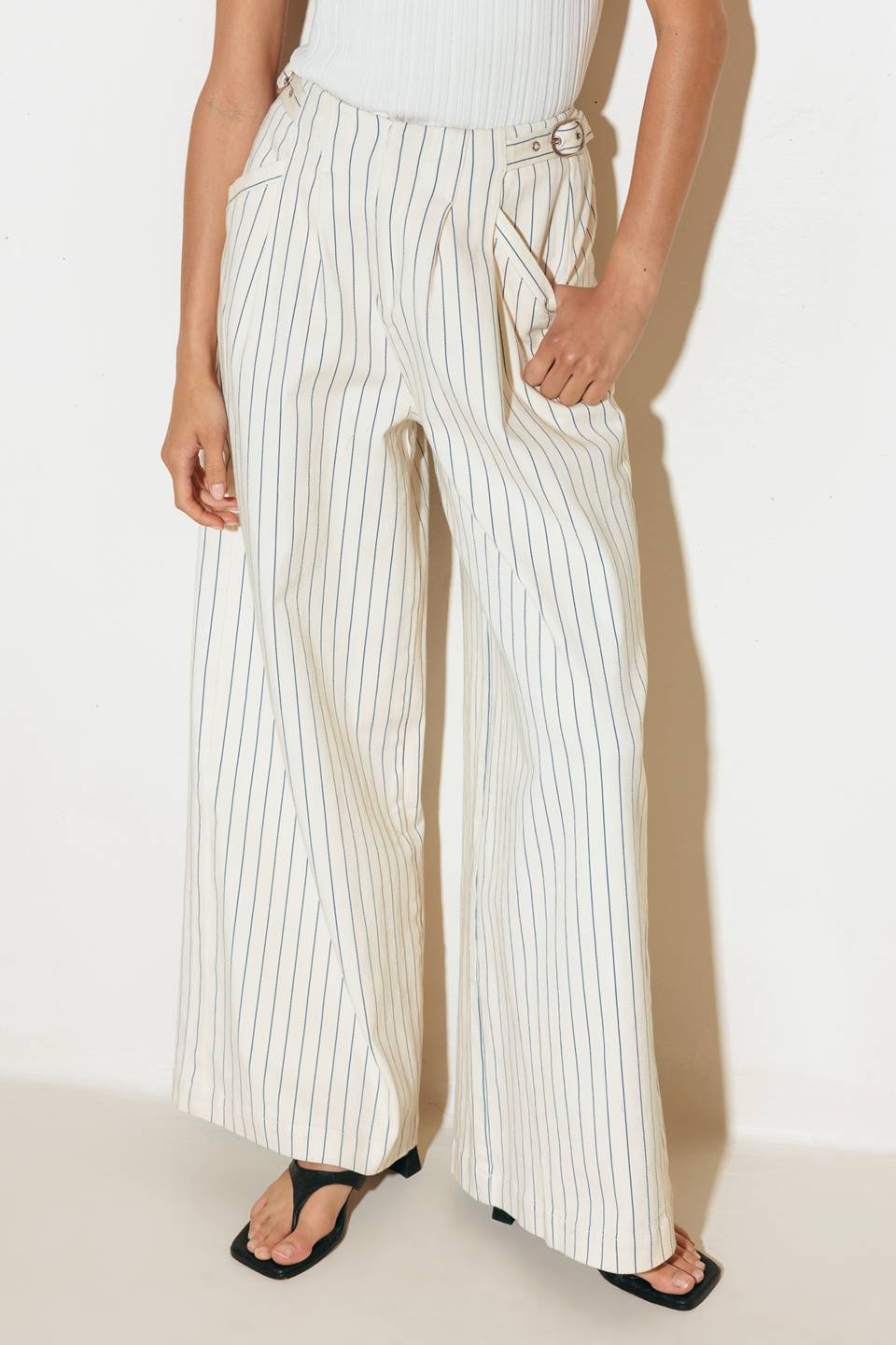 A striped woven pant featuring front closure, side pockets and wide leg.