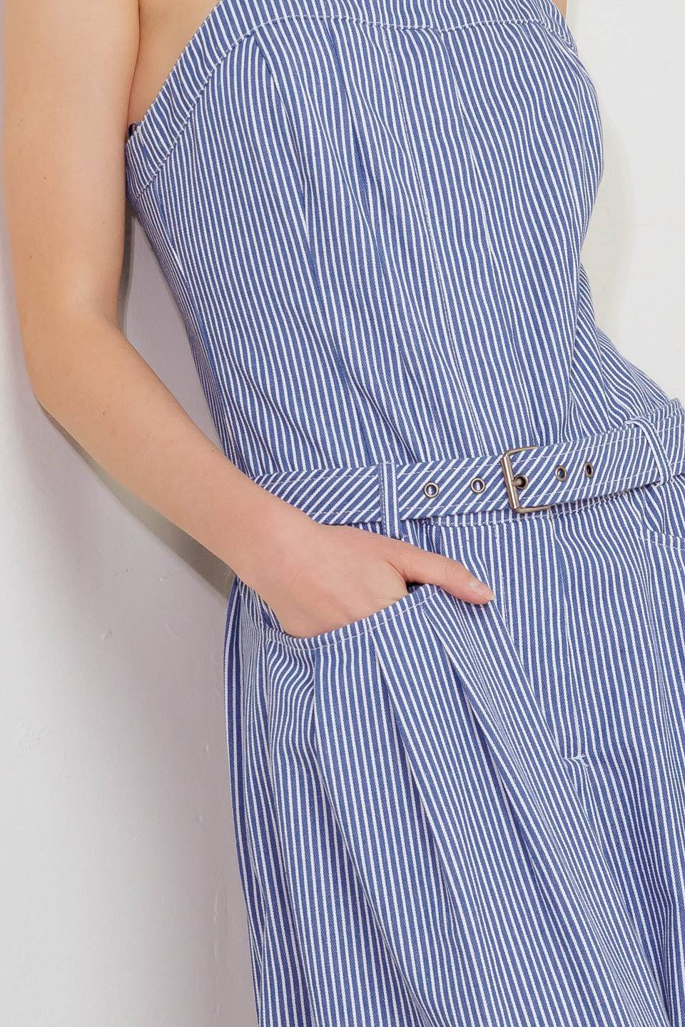 A striped woven jumpsuit featuring straight neckline, straps, front closure, self belt, side pockets and wide leg.