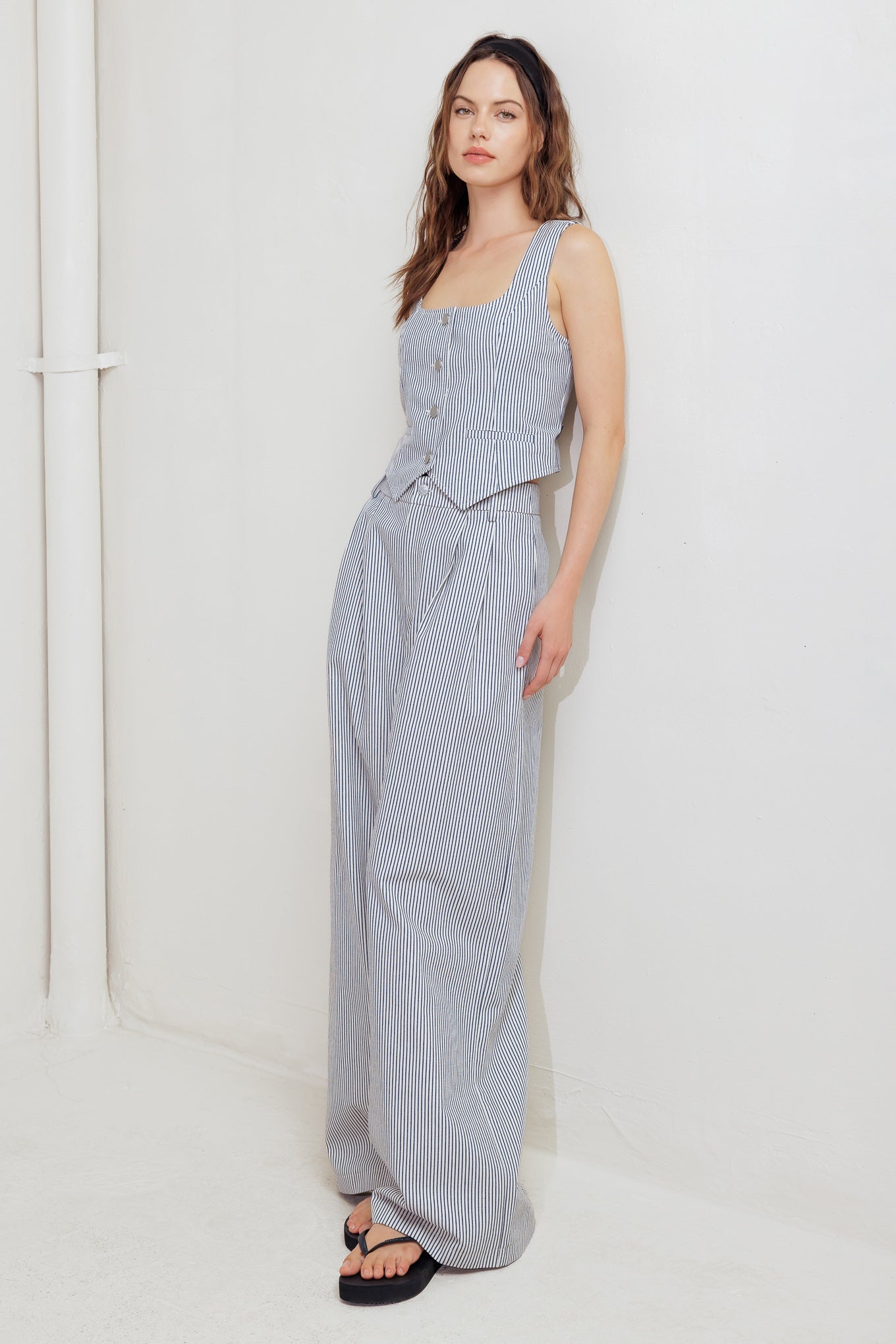 A striped woven pant featuring front closure, pockets and wide leg.