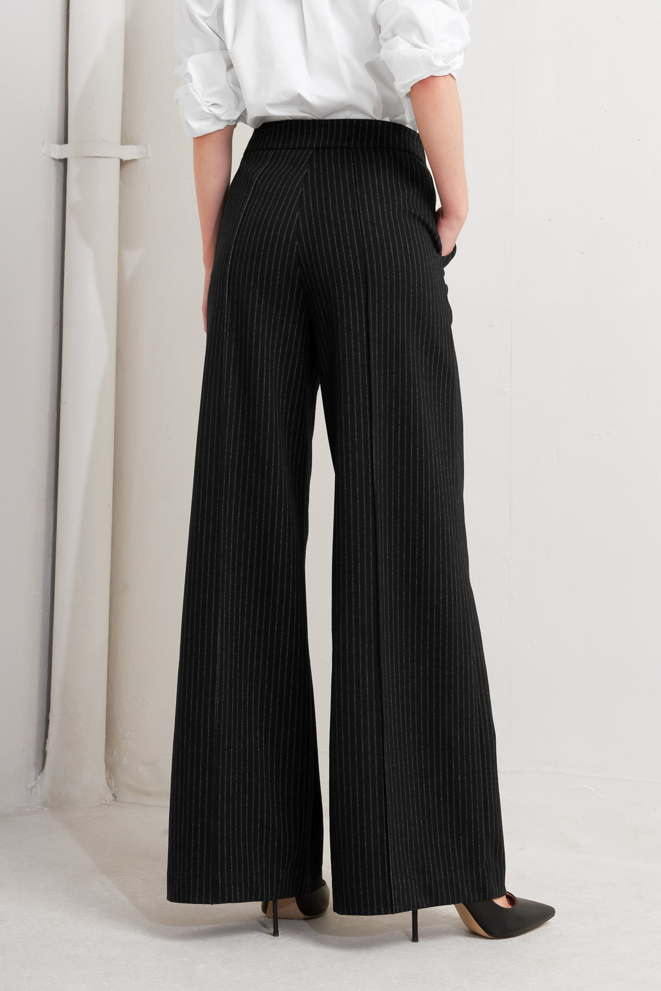 A striped black woven pant with front closure, side pocket and wide leg.
