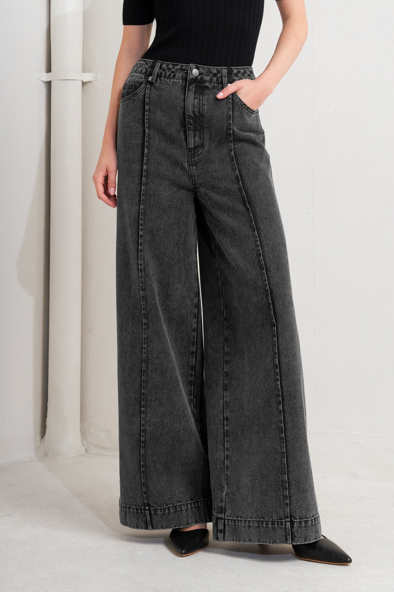 A washed denim pant featuring front button closure, side/back pocket and wide leg.