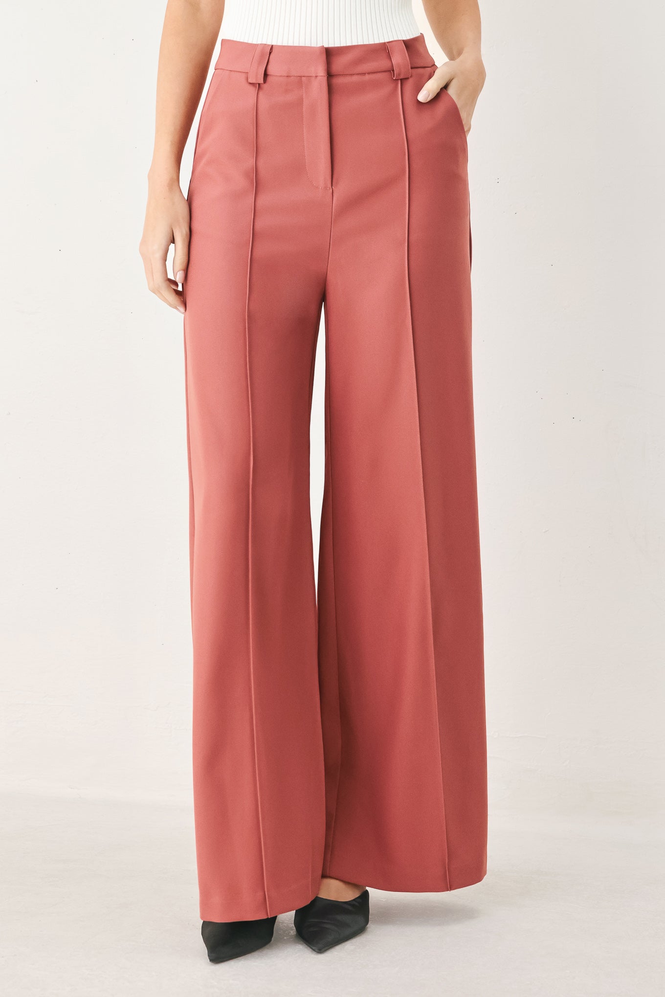 Woman wearing pink mauve woven wide-leg trouser pants with front closure, side pockets | FREEMARKET