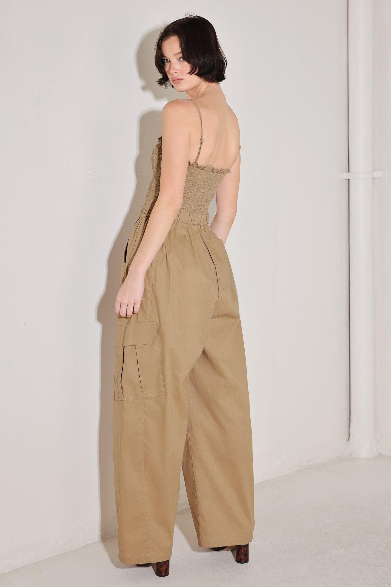 A solid woven jumpsuit featuring straight neckline with ruffle edge, straps, smocked bodice, elastic waist with tie, pockets and wide leg
Details:
Self : 95% Cotton 5% Spandex
Size & Fit
- Model is 5`8" And Wearing Size Small
- Measurements Taken From Size Small
- Approx. Length: 59"