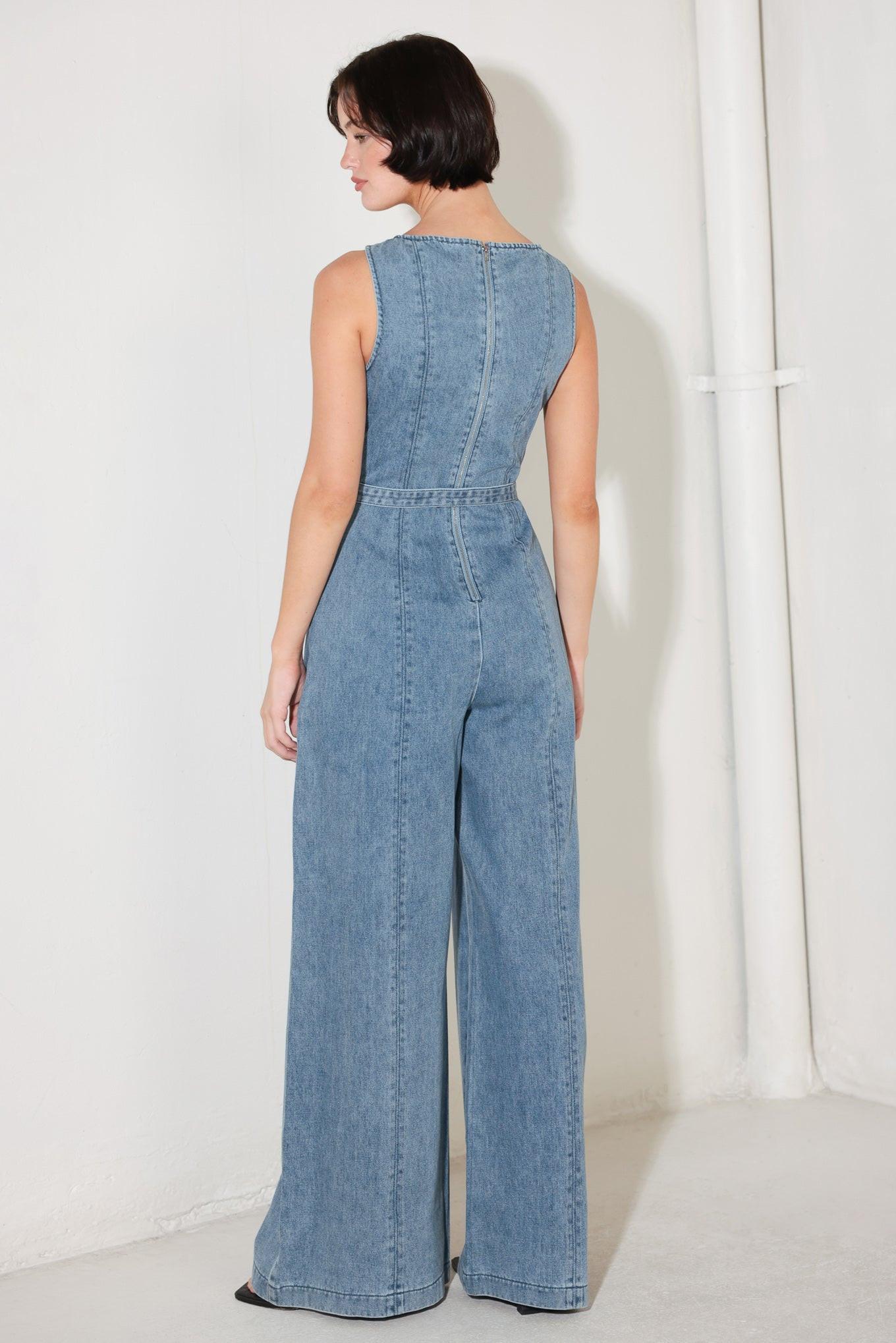 A washed denim jumpsuit featuring wide neckline, sleeveless, self belt, wide leg and back zipper closure
Details:
Self : 90.2% Cotton 4.8% Viscose 5% Polyester
Size & Fit
- Model is 5`8" And Wearing Size Small
- Measurements Taken From Size Small
- Approx. Length: 59"