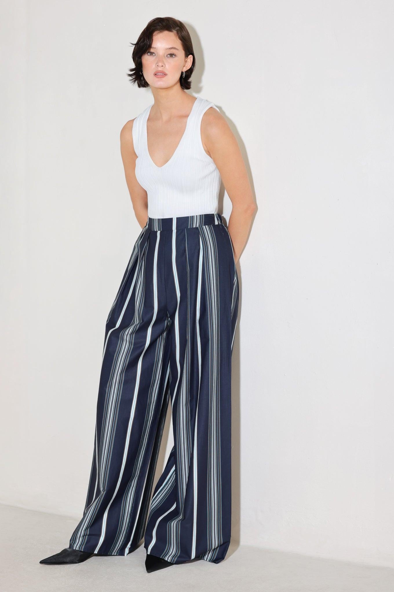 A striped woven pant featuring front pleat, wide leg and elasticized back waistband. Matching top FT1821B
Details:
Self : 100% Cotton
Size & Fit
- Model is 5`8" And Wearing Size Small
- Measurements Taken From Size Small
- Approx. Length: 44"