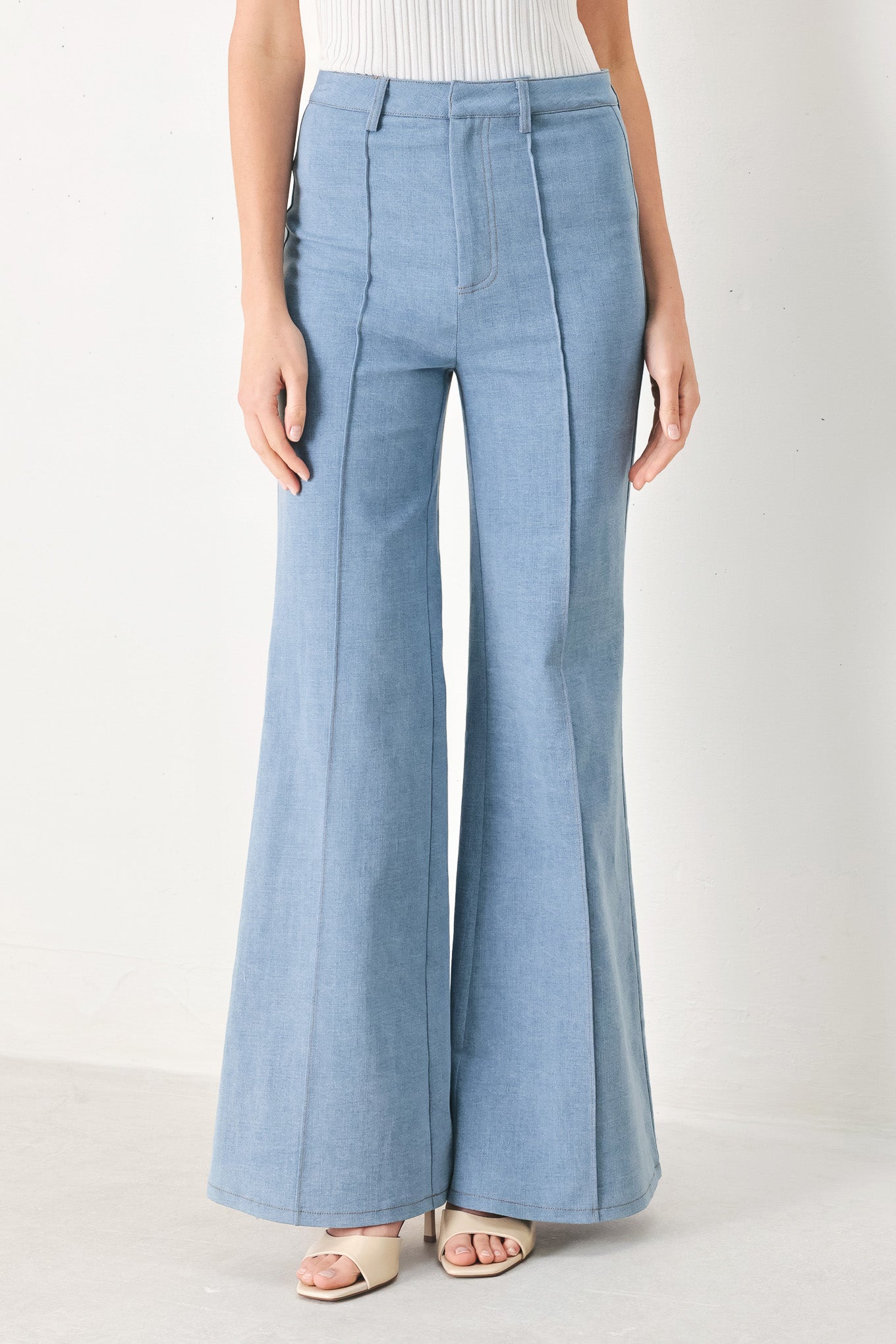 Woman wearing light blue boot cut pant with front closure | FREEMARKET | Flying Tomato