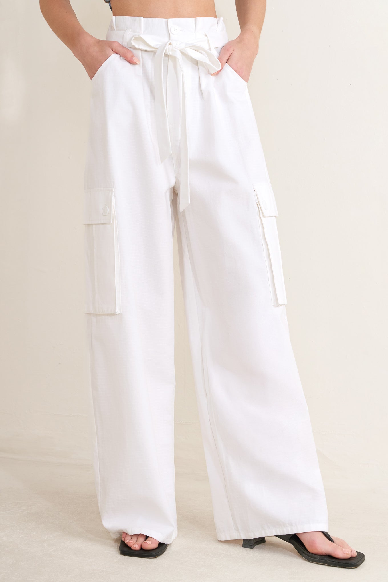 Woman wearing white wide-leg cargo pants with sash tie | FREEMARKET | Flying Tomato