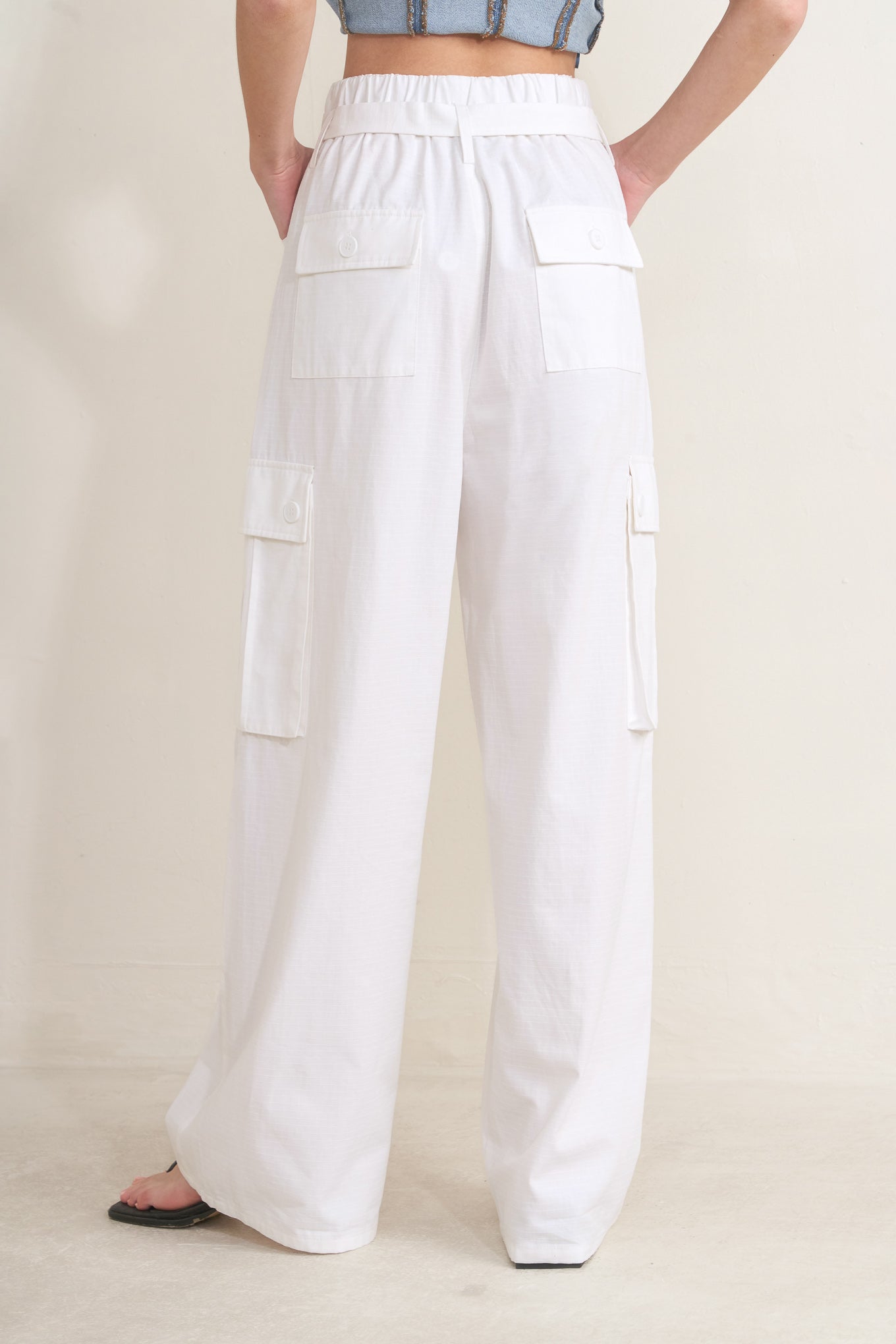 Woman wearing white wide-leg cargo pants with sash tie | FREEMARKET | Flying Tomato