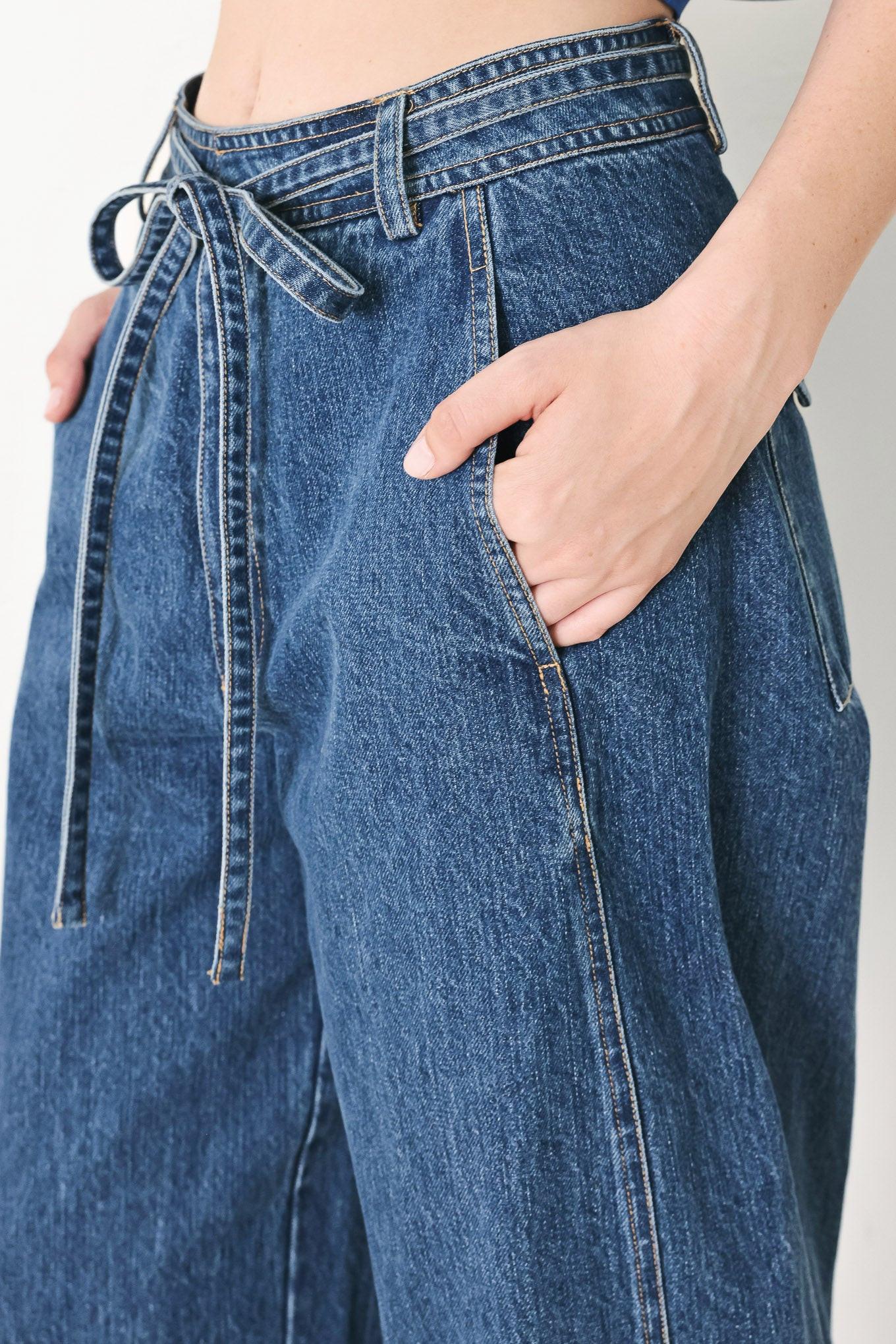 A washed oversized denim pant featuring front closure, side/back pockets and wide leg
