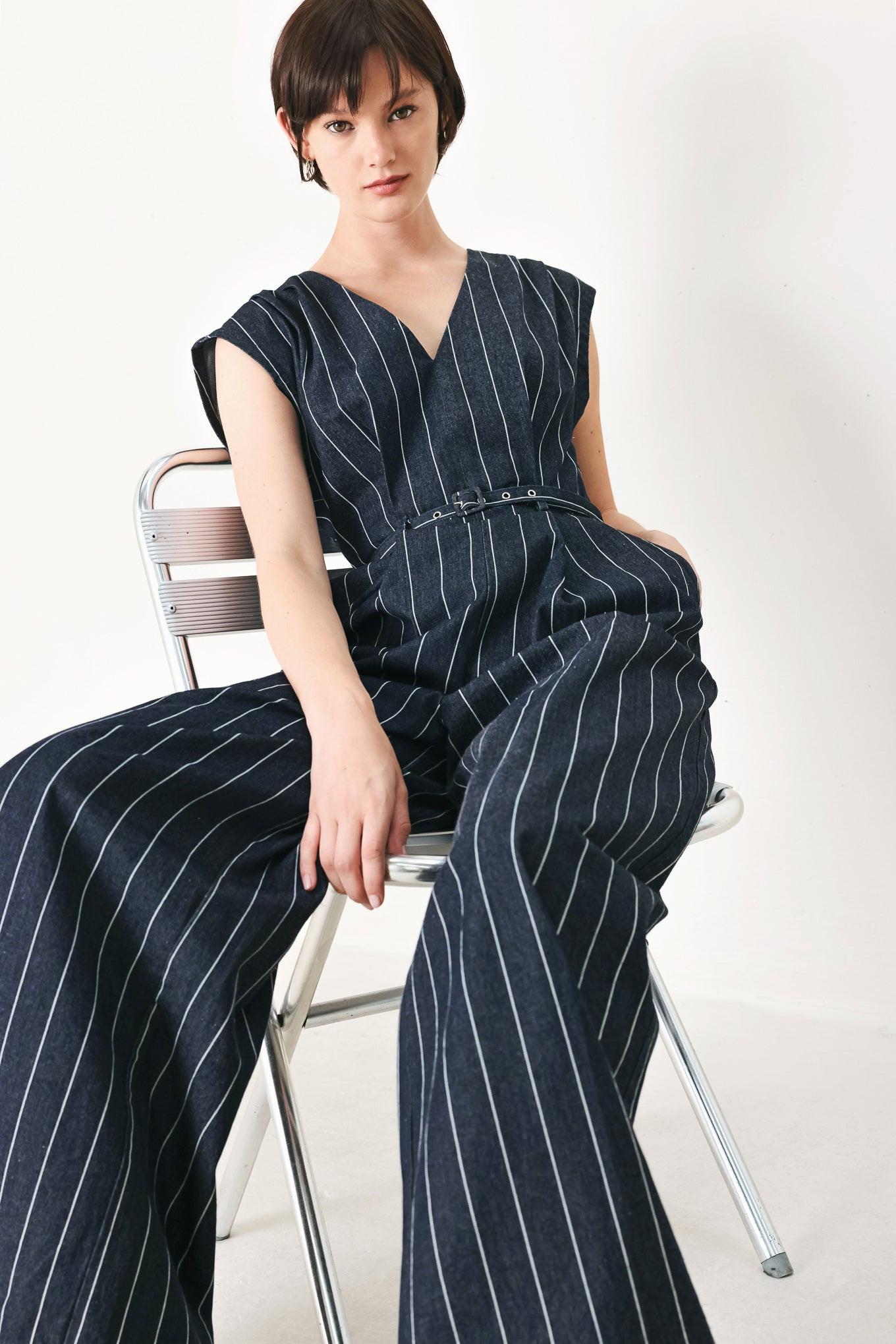 A striped woven jumpsuit featuring V neckline, short sleeve, self skinny belt, wide leg and back zipper closure