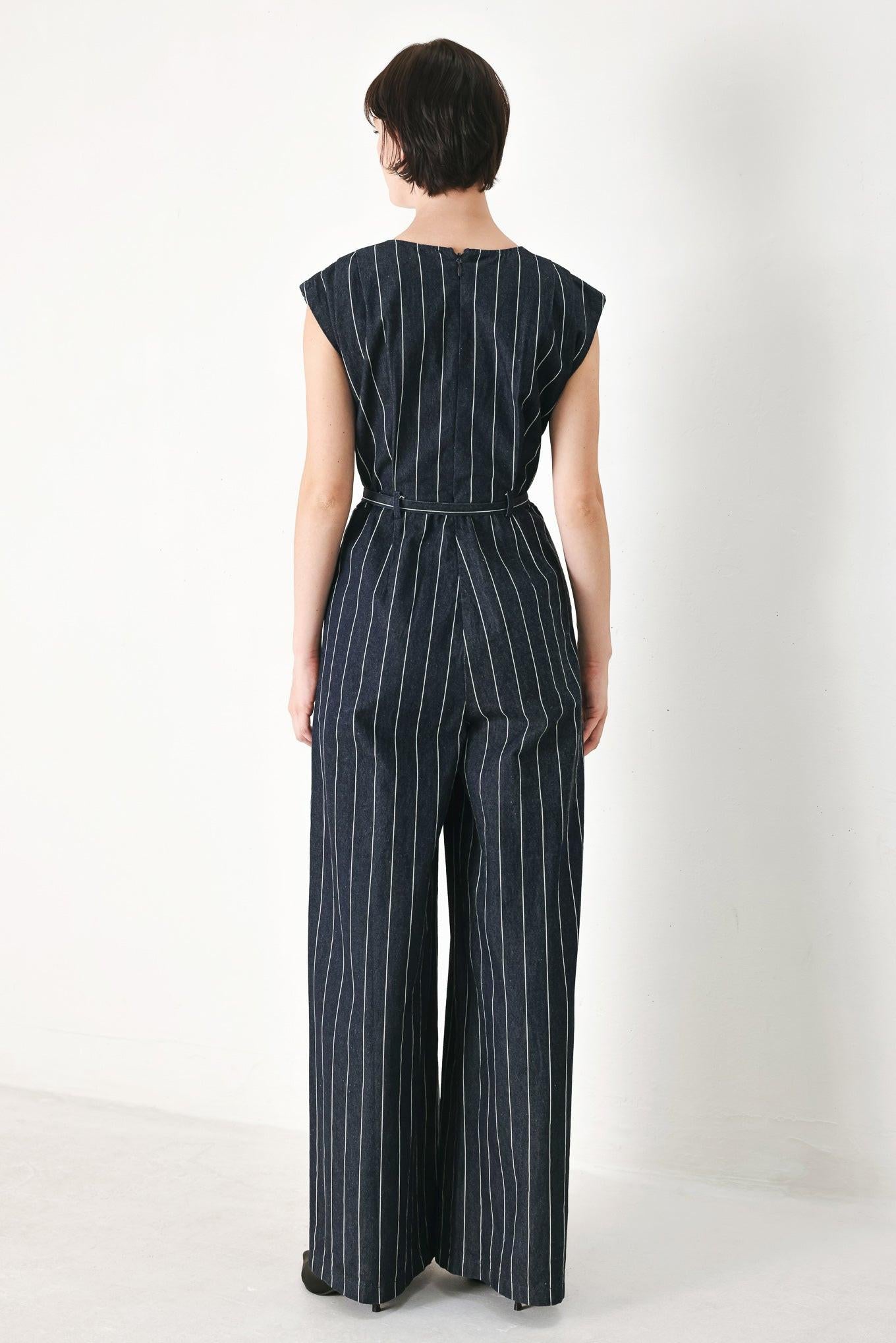 A striped woven jumpsuit featuring V neckline, short sleeve, self skinny belt, wide leg and back zipper closure