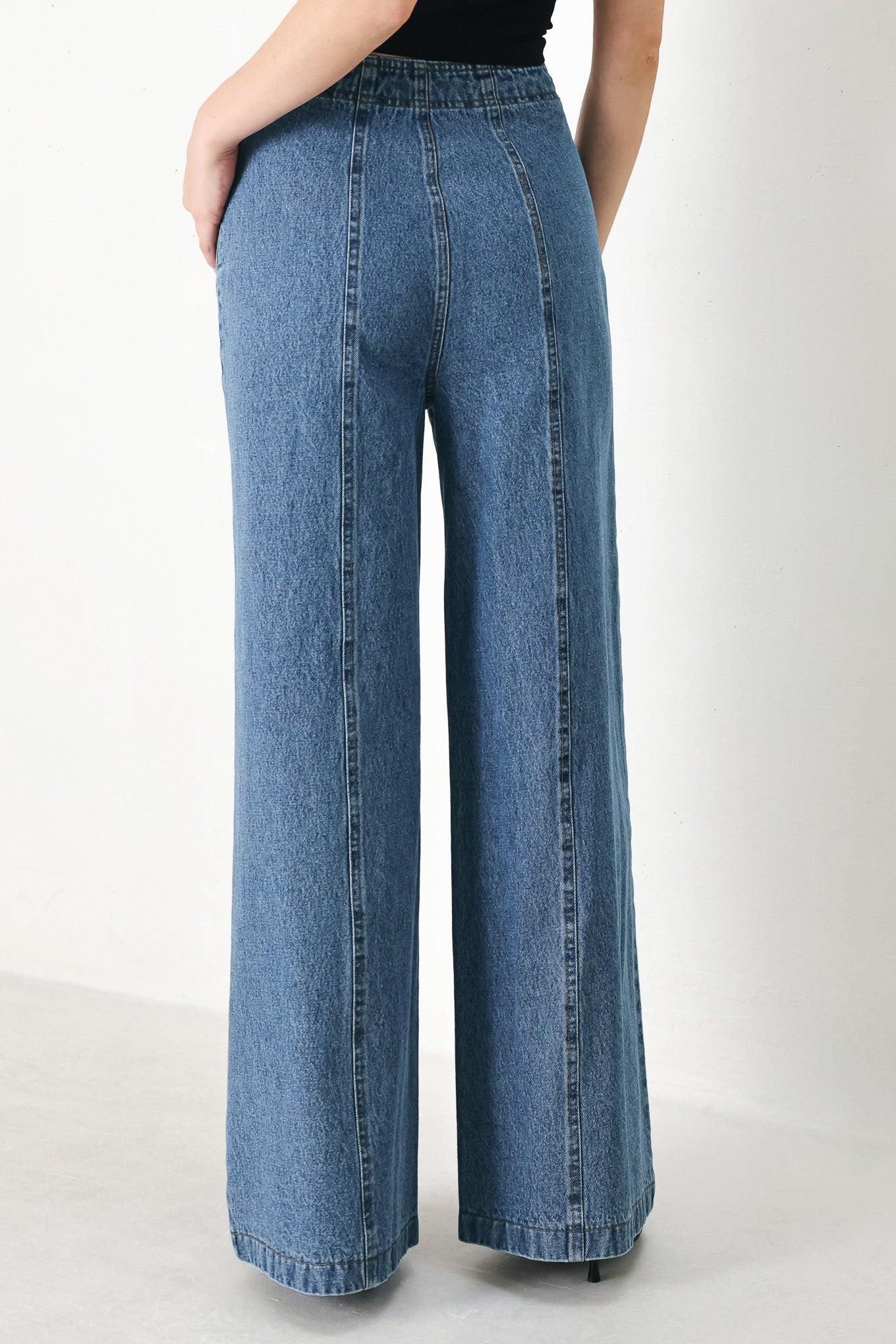 A washed denim pant with elastic waist and wide leg.