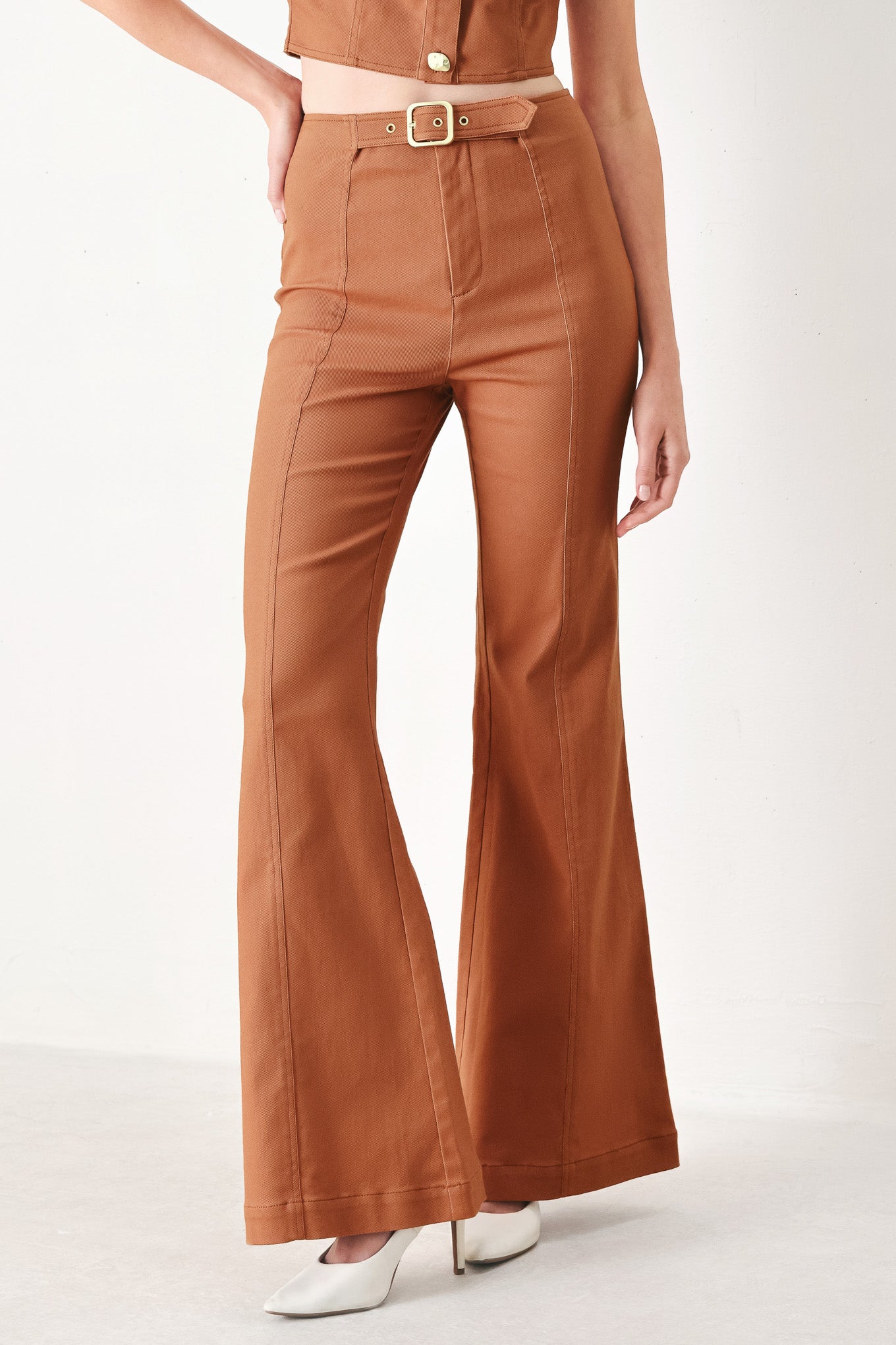 Woman wearing terracotta flared pants with belt tab, front zipper and flare leg | FREEMARKET | Flying Tomato