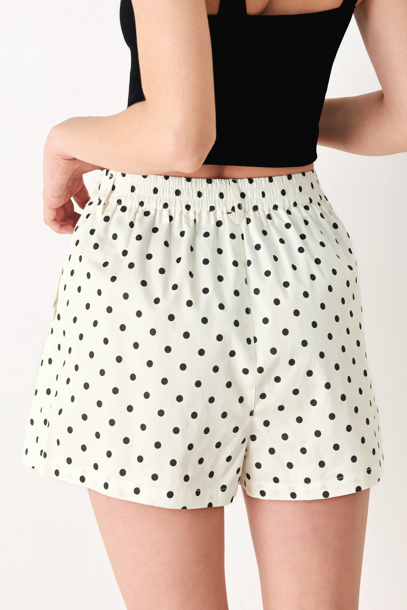 Woman wearing polka dot shorts with front closure and side pockets | FREEMARKET