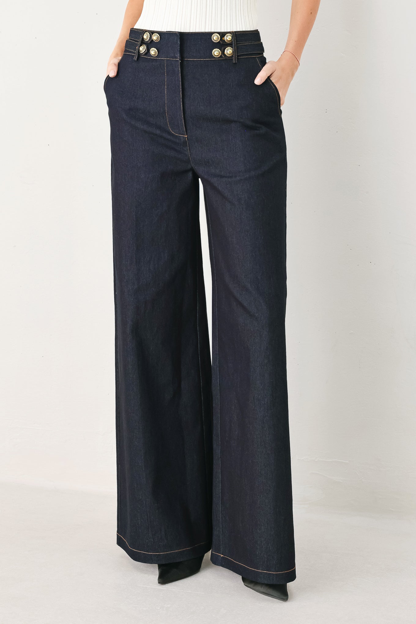 Navy blue wide-leg pants with gold buttons on a white background