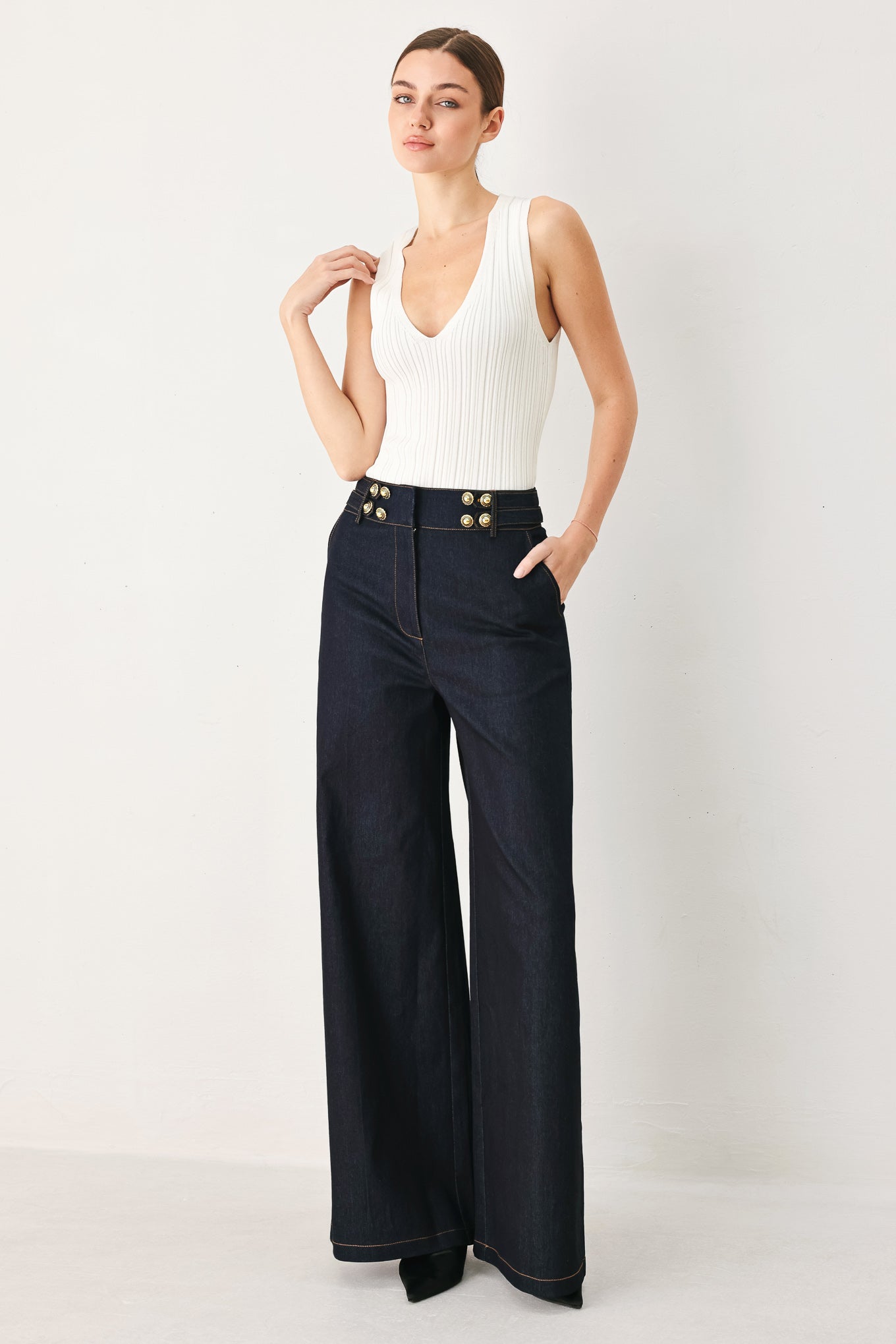 Woman wearing dark denim navy blue wide-leg pants with gold buttons | FREEMARKET