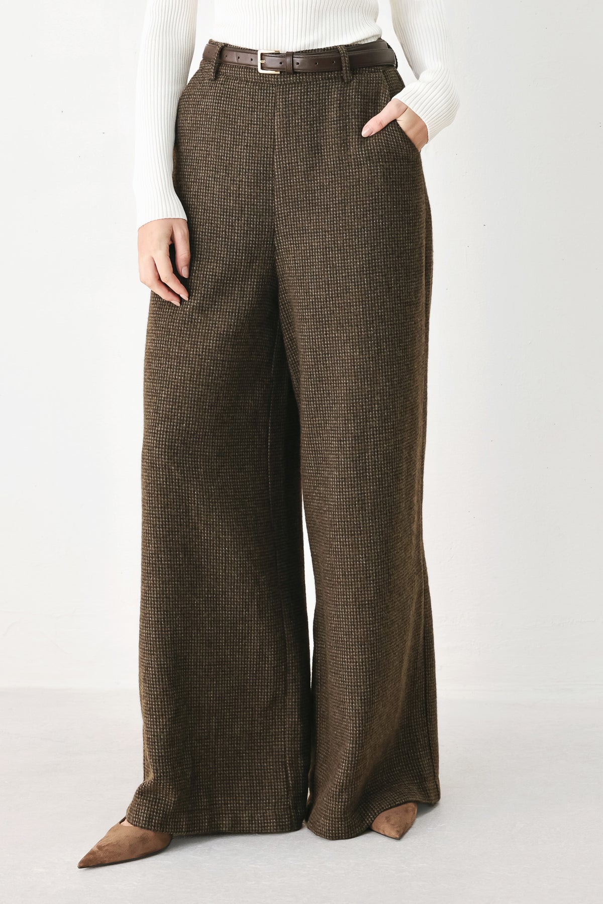 A person wearing high-waisted, wide-leg brown houndstooth trousers with a matching brown belt | FREEMARKET