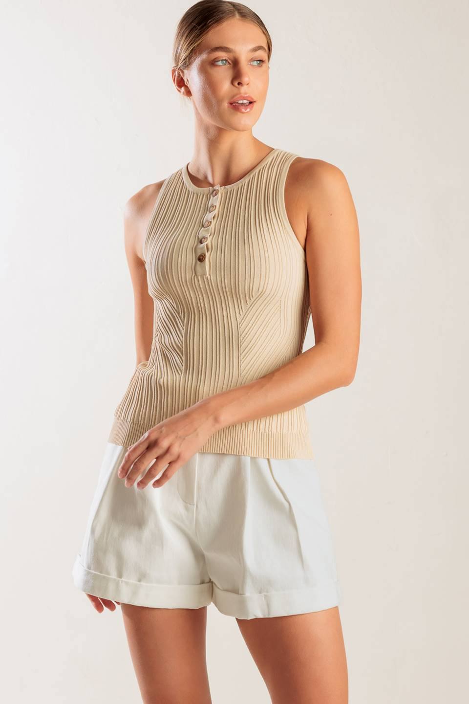 A sleeveless, sweater knit tank top with front button down