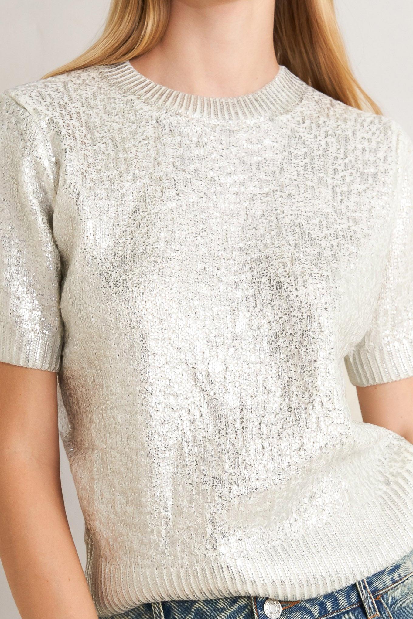 A foiled sweater knit top featuring crew neckline and short sleeve
