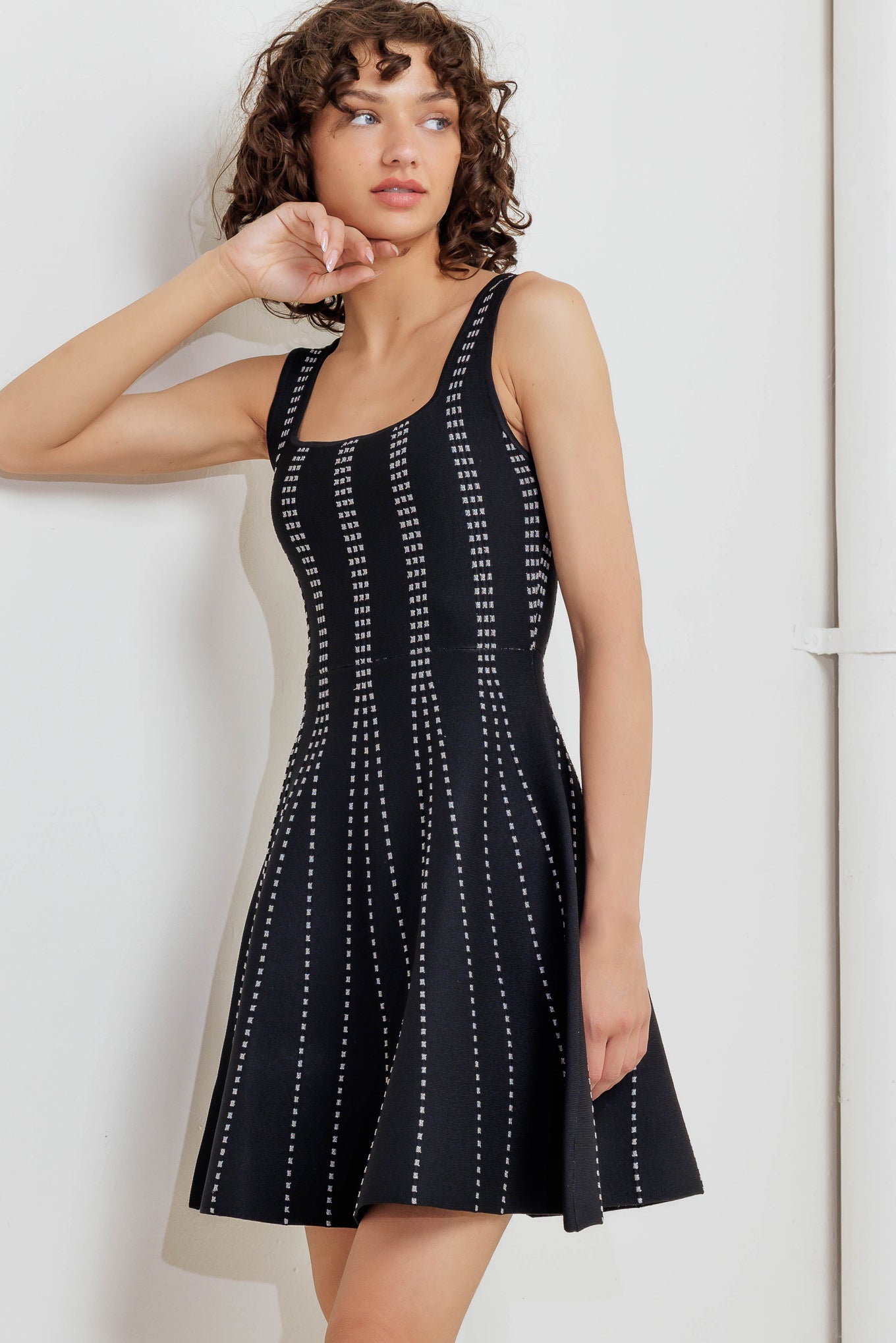 A jacquard sweater knit mini dress featuring square neckline, sleeveless and flare skirt