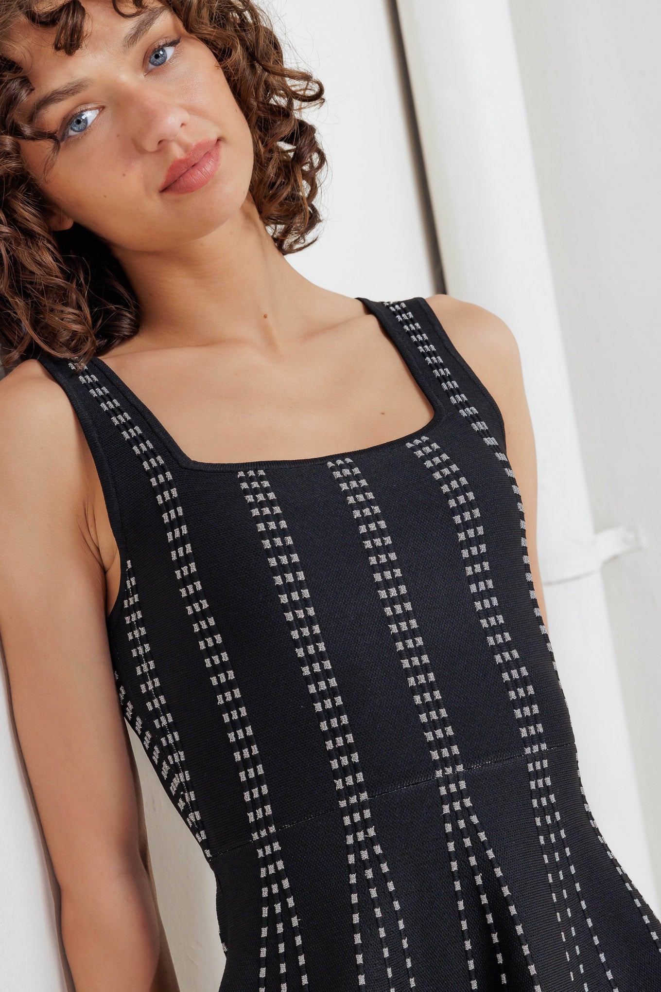 A jacquard sweater knit mini dress featuring square neckline, sleeveless and flare skirt