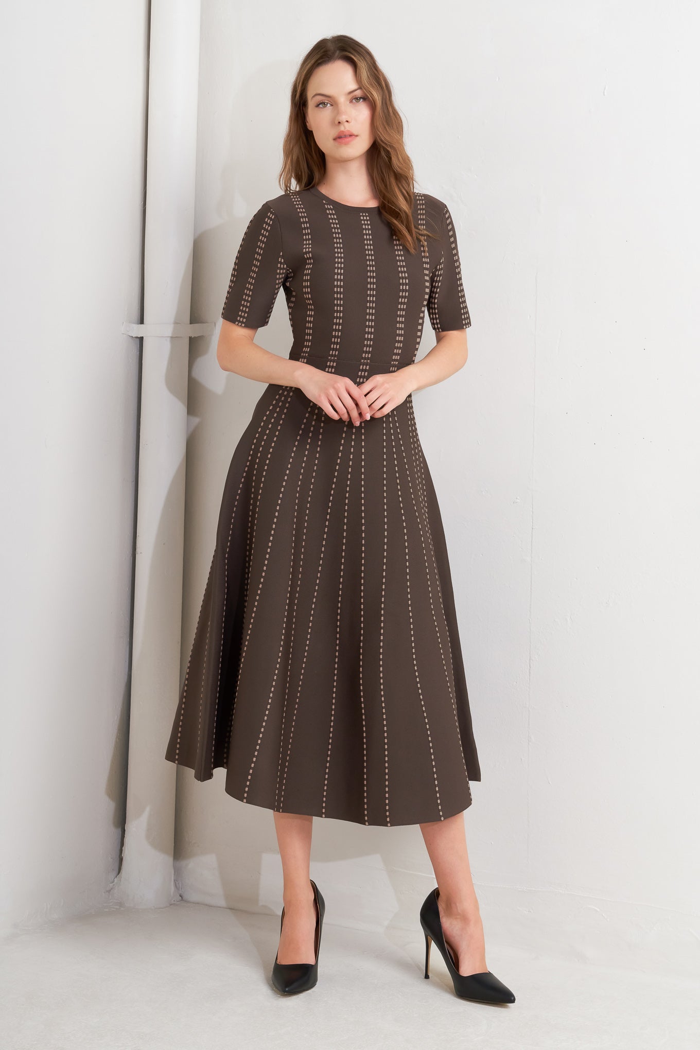 A sweater knit midi dress featuring round neckline, short sleeve and circle skirt