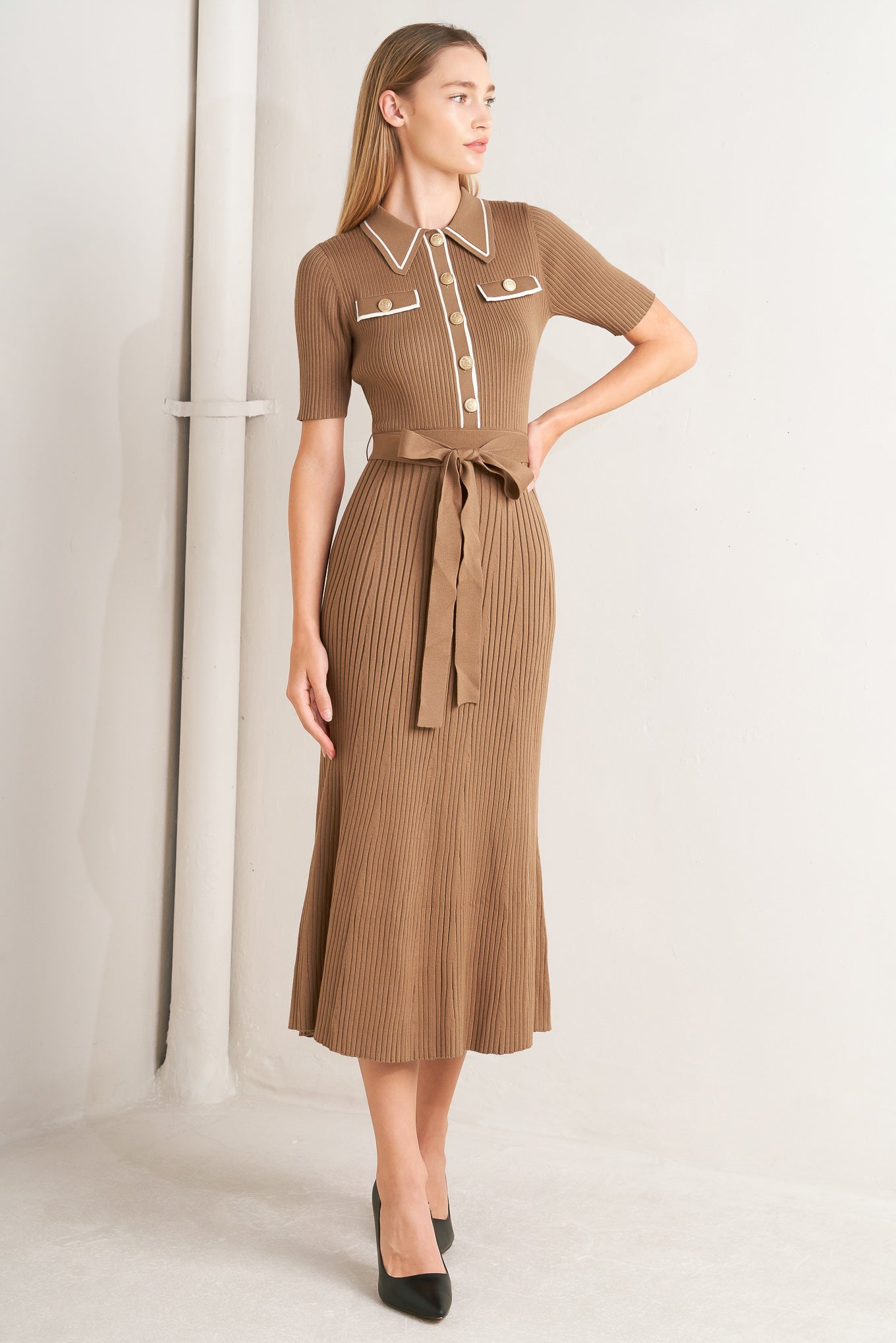 A ribbed sweater knit midi dress featuring collar, front button down and self sash tie