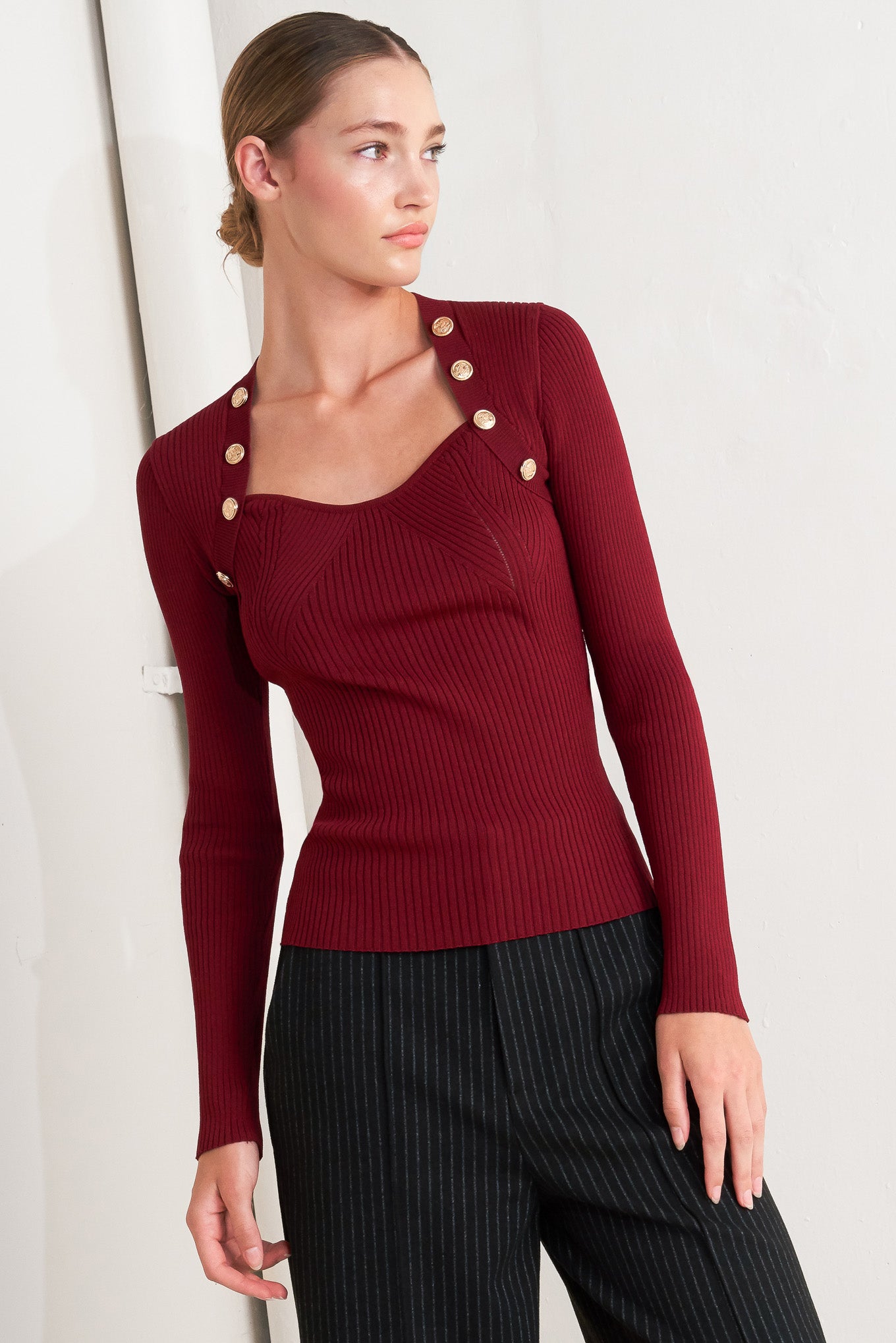 A sweater knit top with button detail