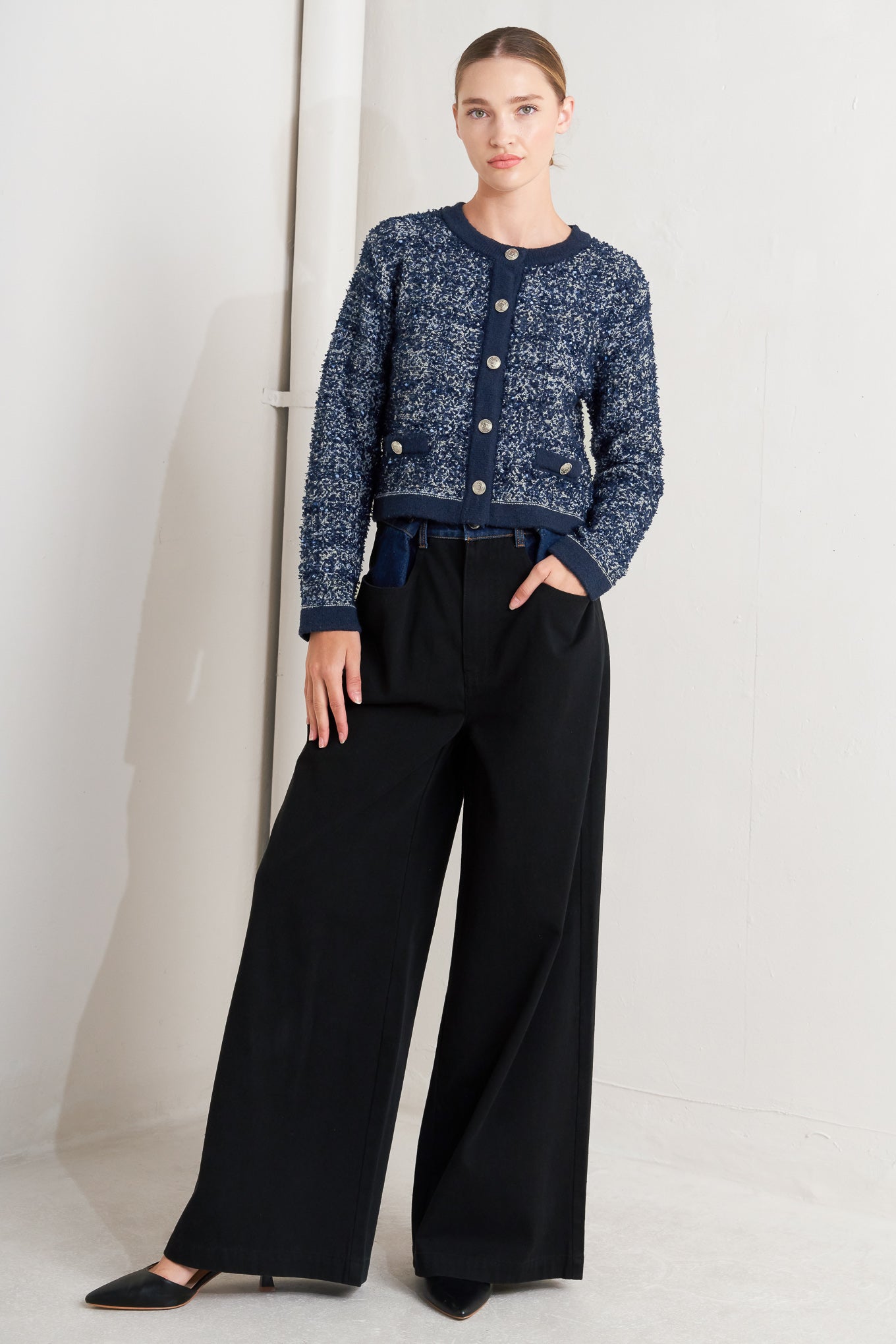 A sweater knit cardigan with front button closure