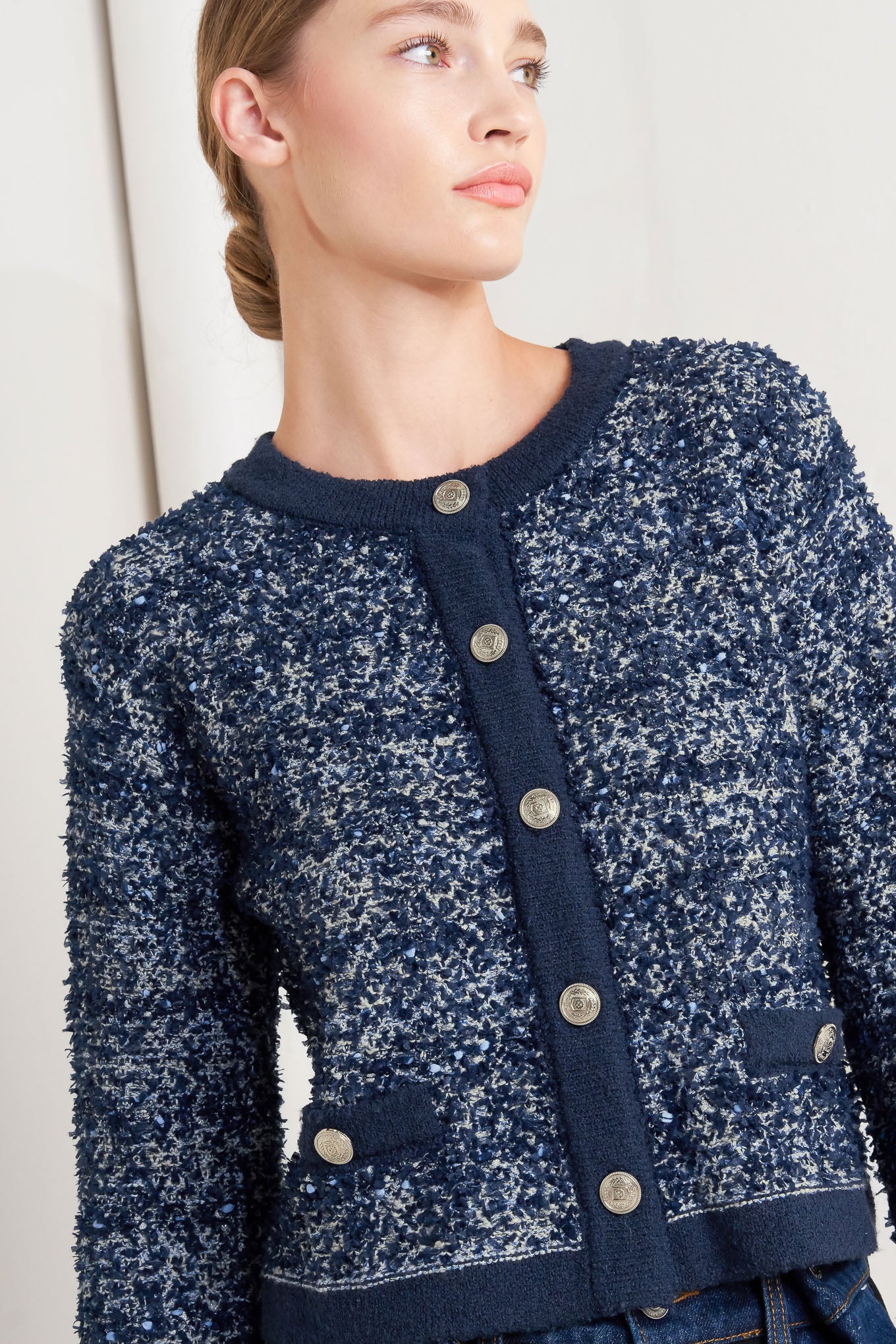 A sweater knit cardigan with front button closure