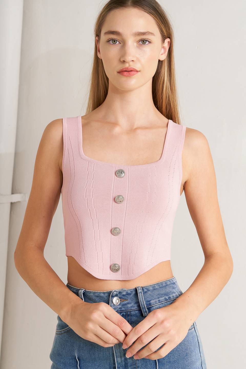 A sweater top featuring square neckline, sleeveless and button front detail