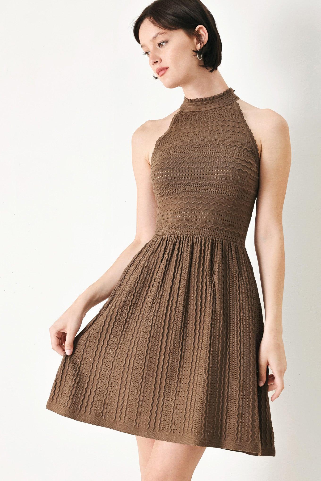 A sweater knit mini dress with halter neckline and back neck button closure