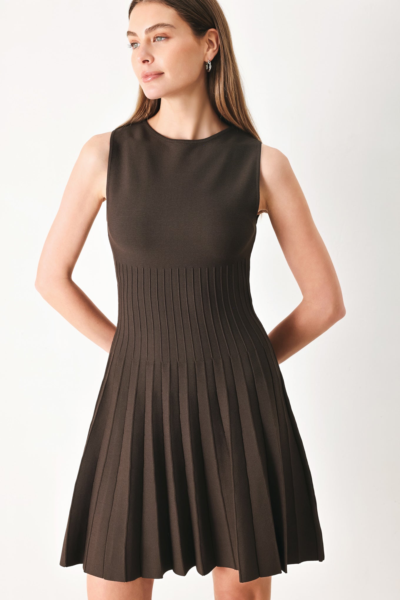 Woman wearing a brown sleeveless sweater knit mini dress with pleated skirt | FREEMARKET | Flying Tomato