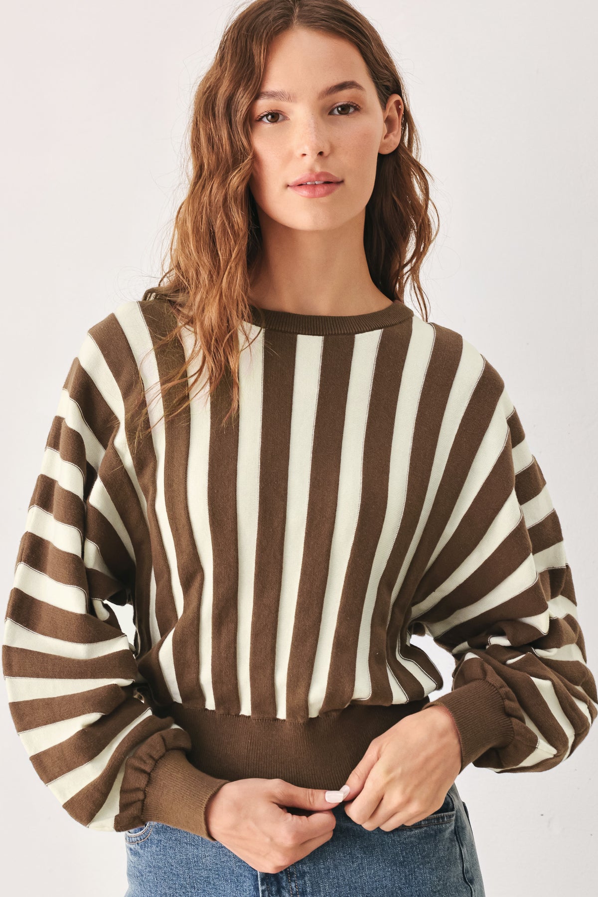 A woman wearing a brown and ivory striped long-sleeve knit top | FREEMARKET