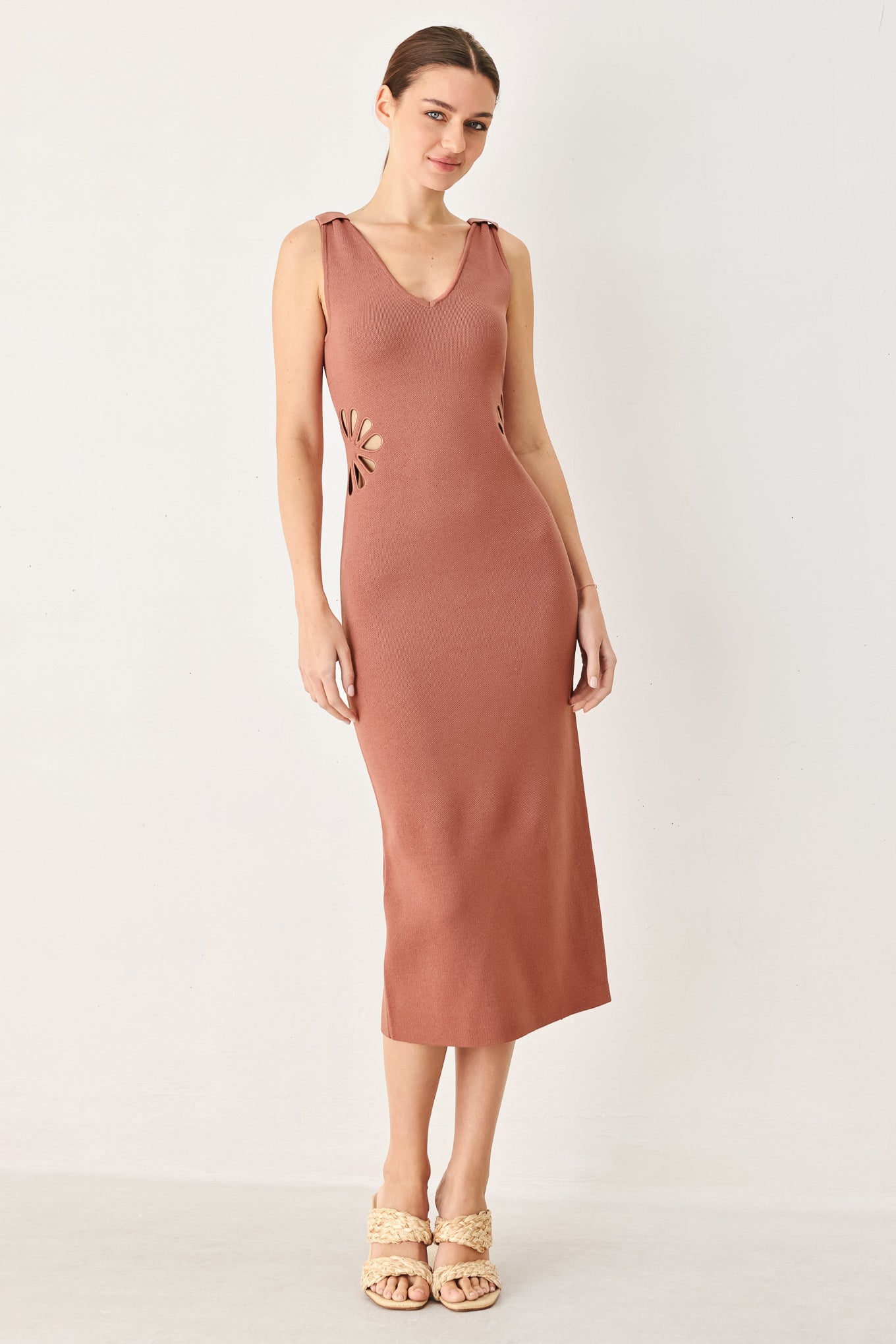 A sweater knit midi dress featuring V neckline and side cut out