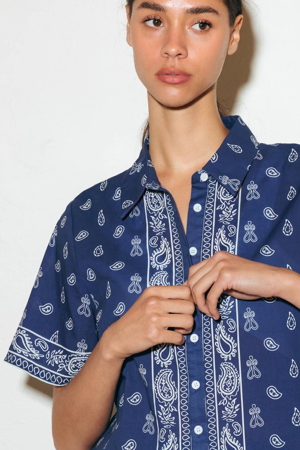 A printed navy and white woven shirt featuring collar, button down and short sleeve.