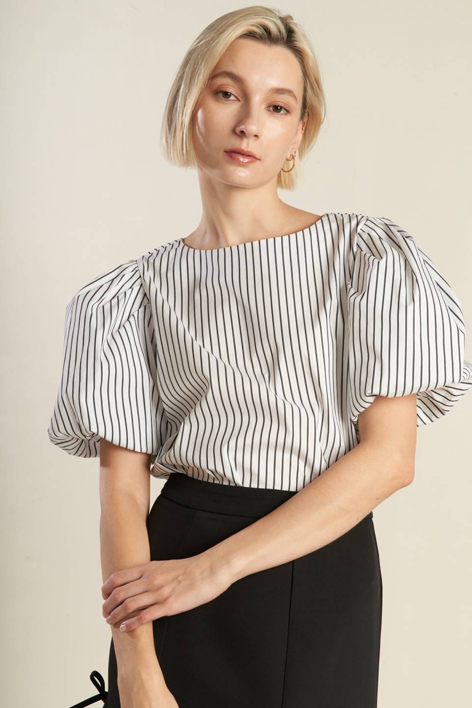 A striped woven top featuring round neckline, puffy sleeve and back keyhole button closure from Flying Tomato