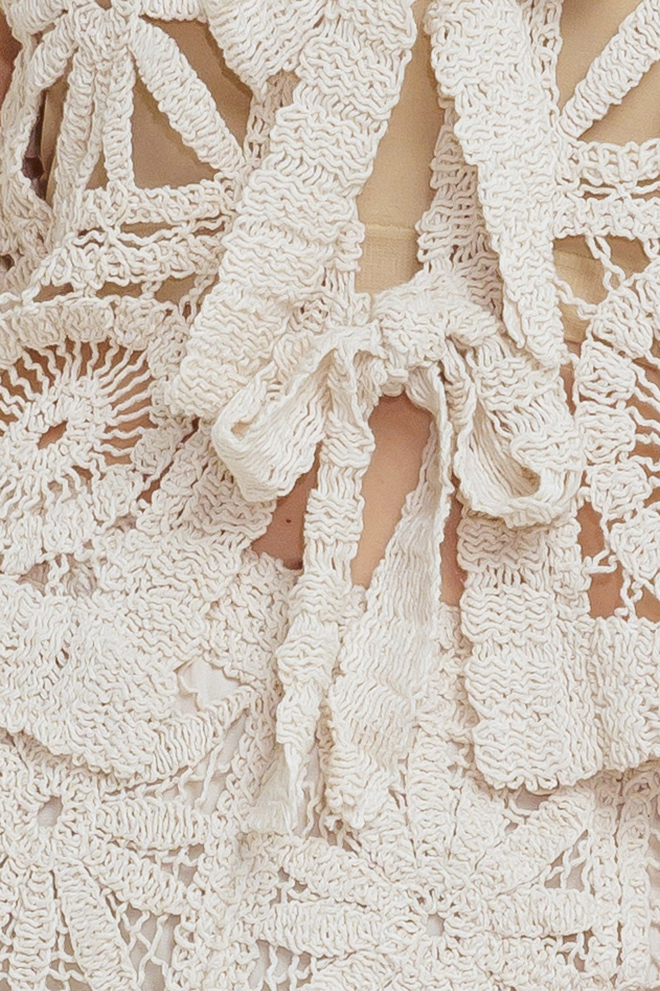 A crochet vest and pant set. Vest featuring front ties and elasticized waist pant