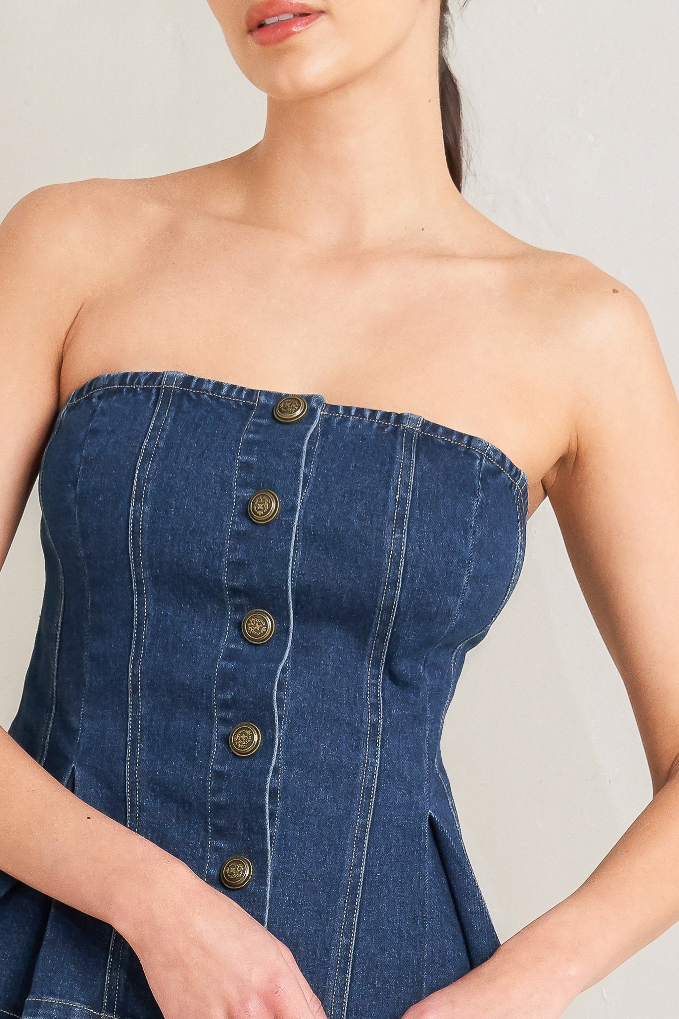 Woman wearing a denim strapless top against a neutral background - Flying Tomato