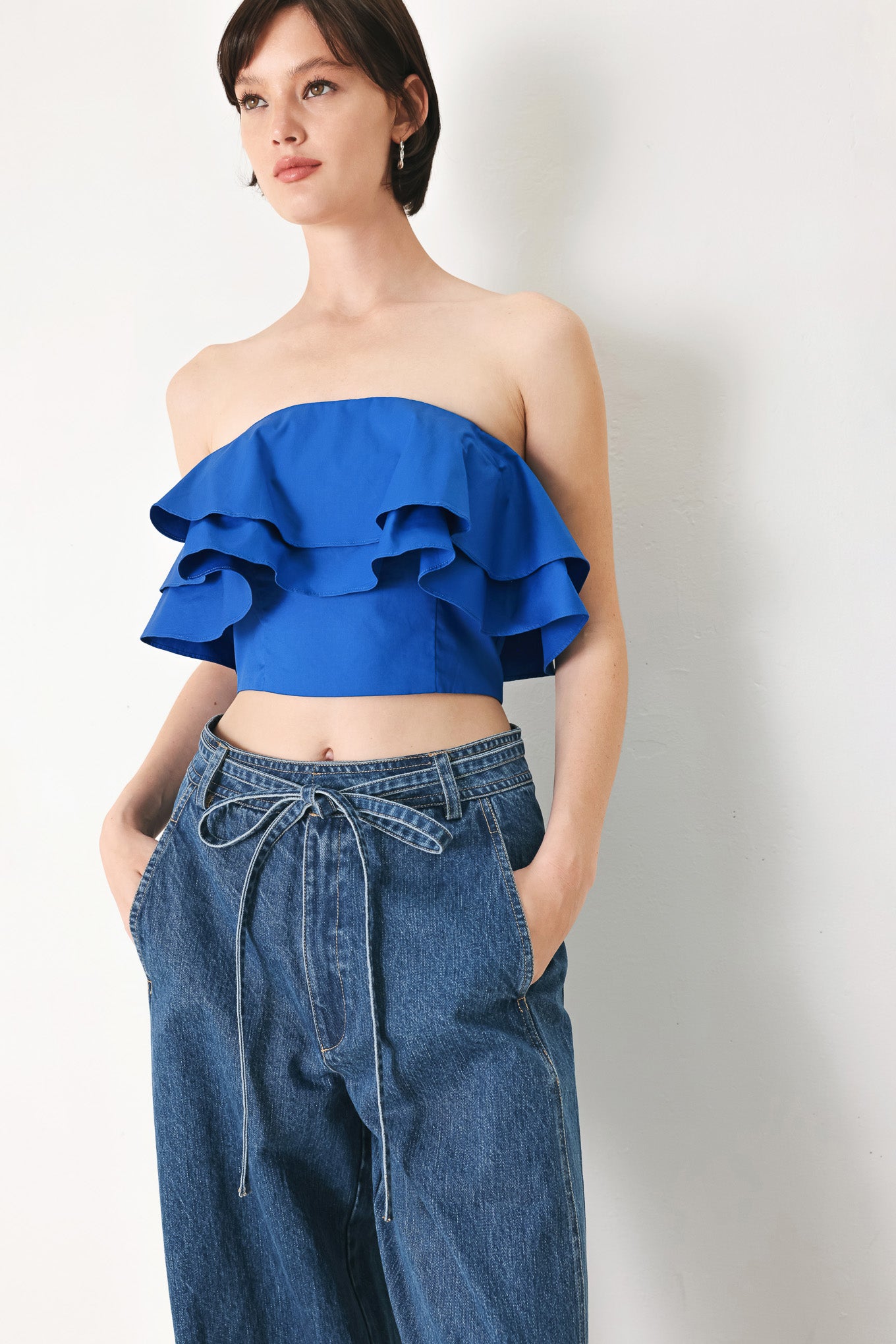 Woman wearing a blue ruffled top | FREEMARKET | Flying Tomato