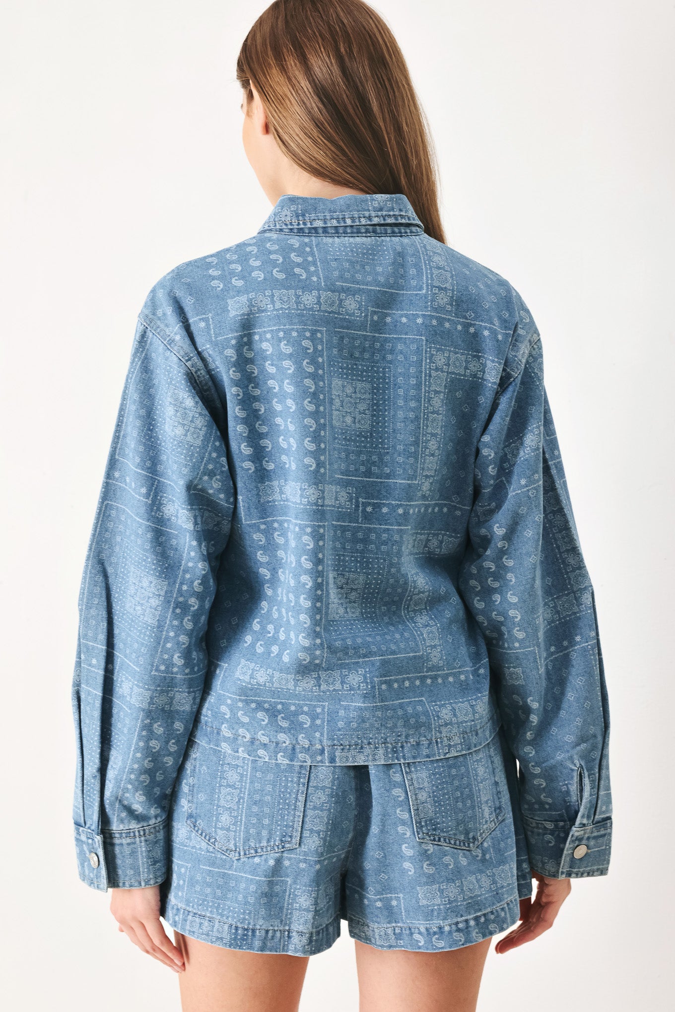 Woman wearing a blue bandana patterned denim jacket with front closure | FREEMARKET | Flying Tomato