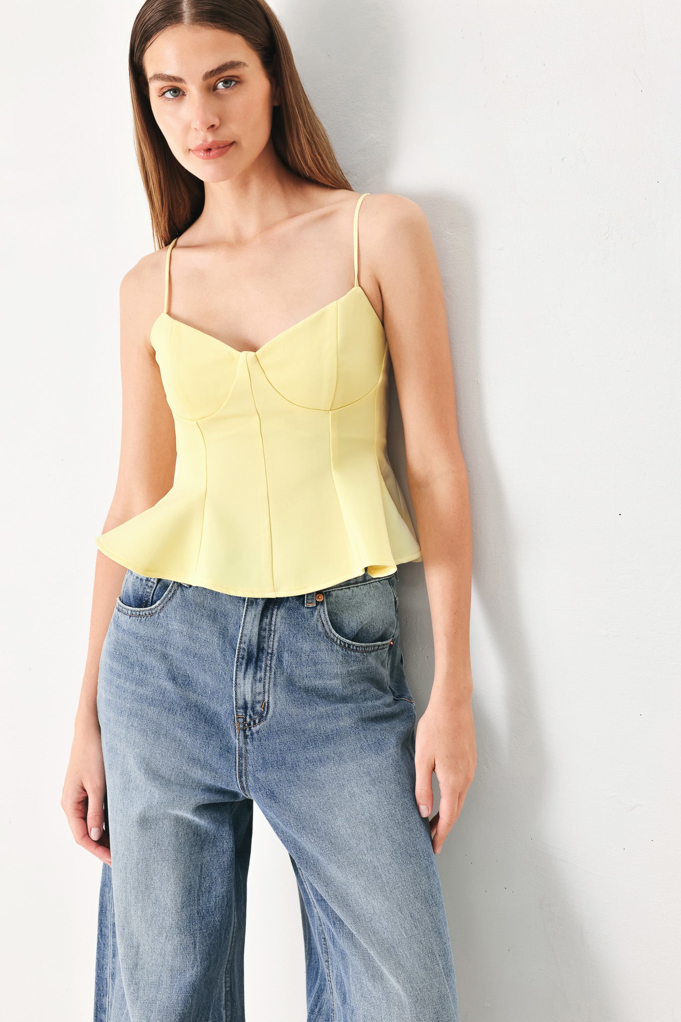 Woman wearing a yellow peplum cami top with back zipper closure | FREEMARKET | Flying Tomato