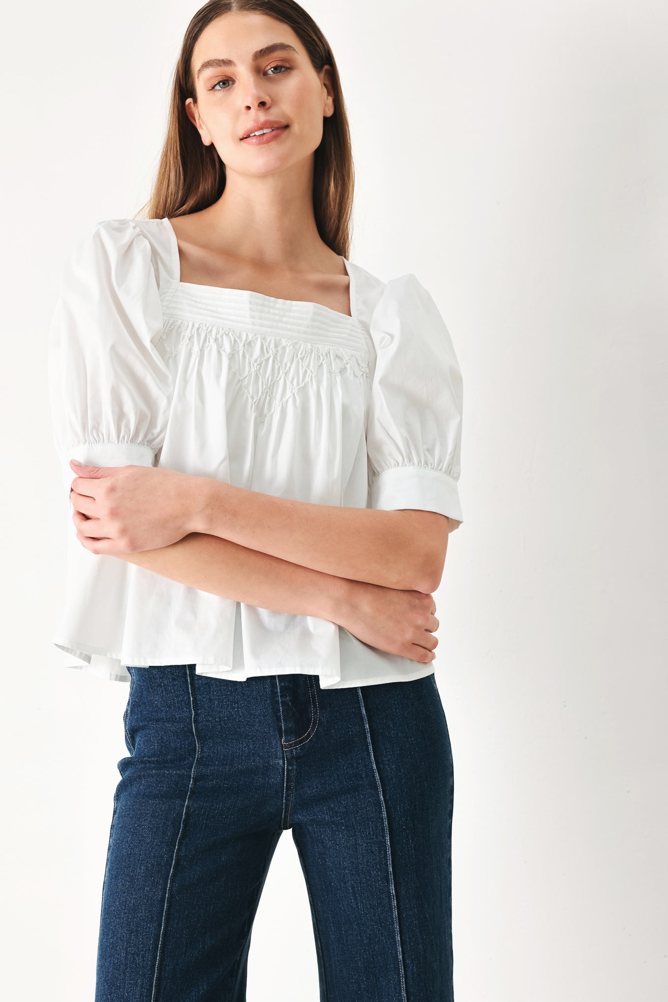 Woman wearing a white blouse featuring square neckline, elbow sleeve with cuff and back button closure | Flying Tomato